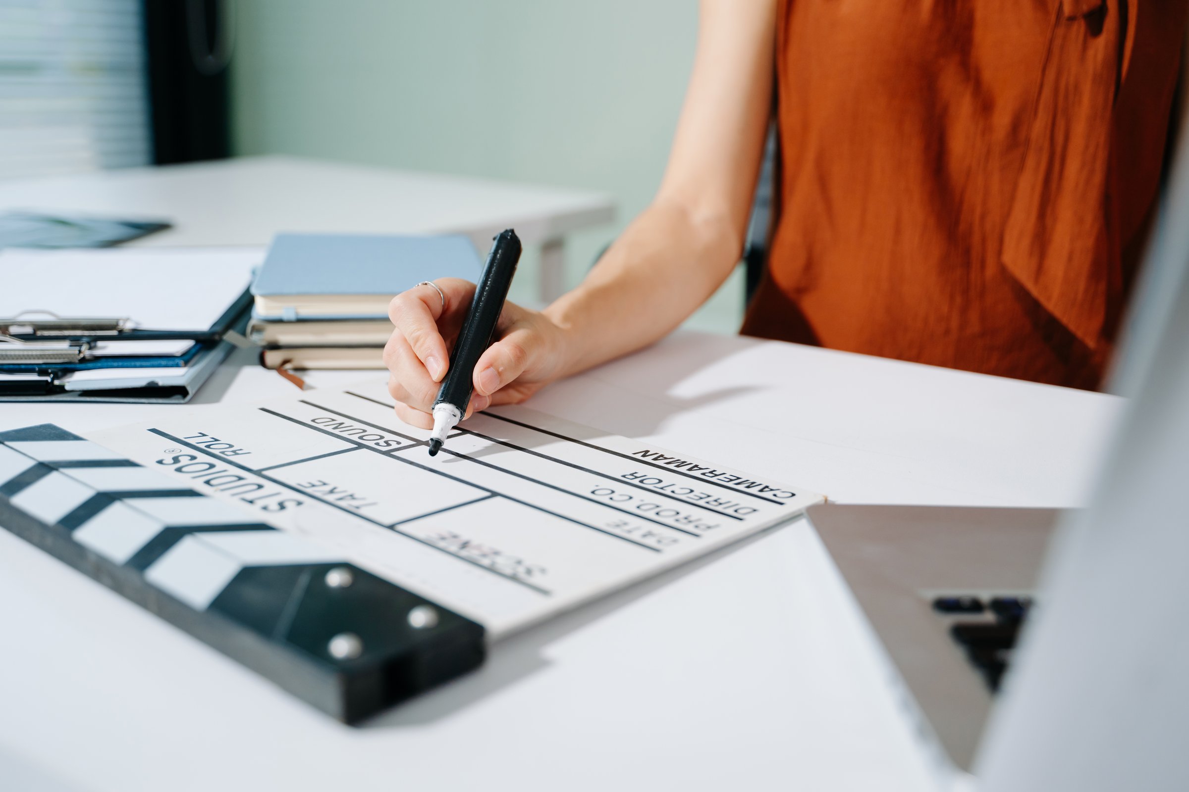 Female filmmaker with tablet and clapperboard