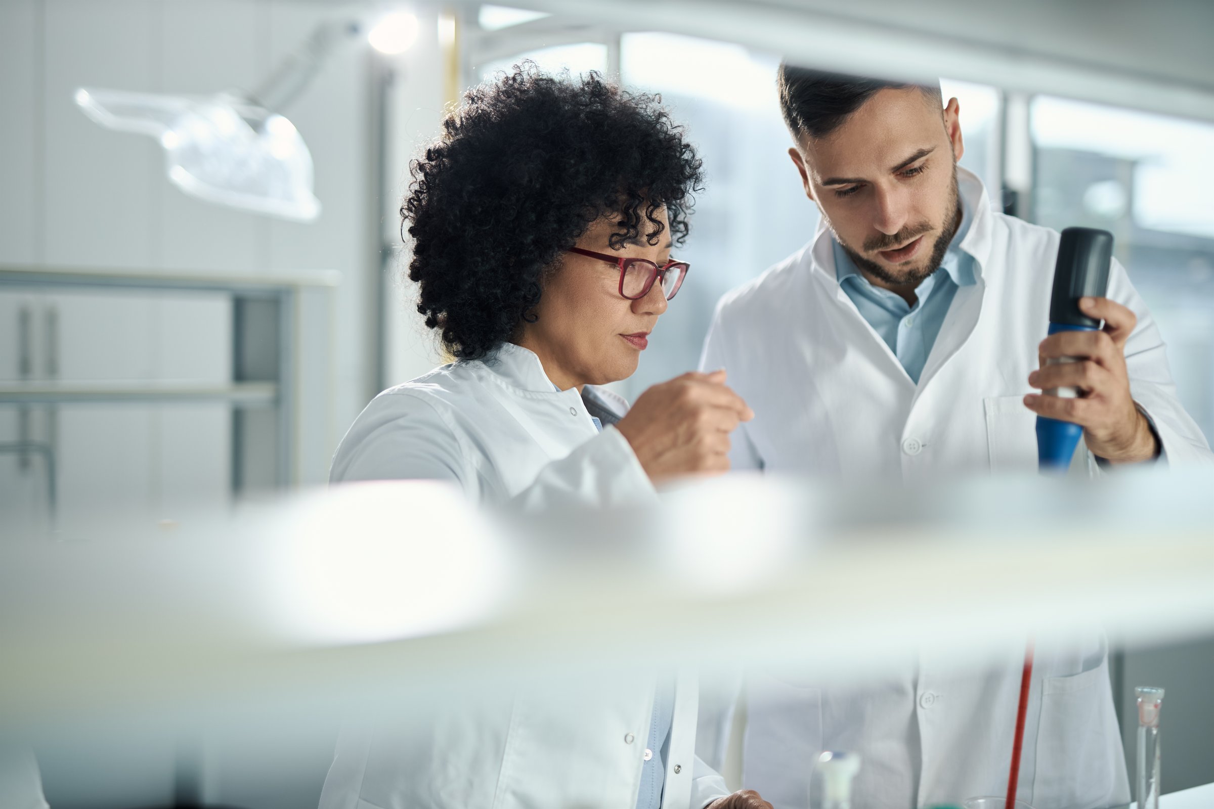 Biotechnologists working on scientific research in laboratory.