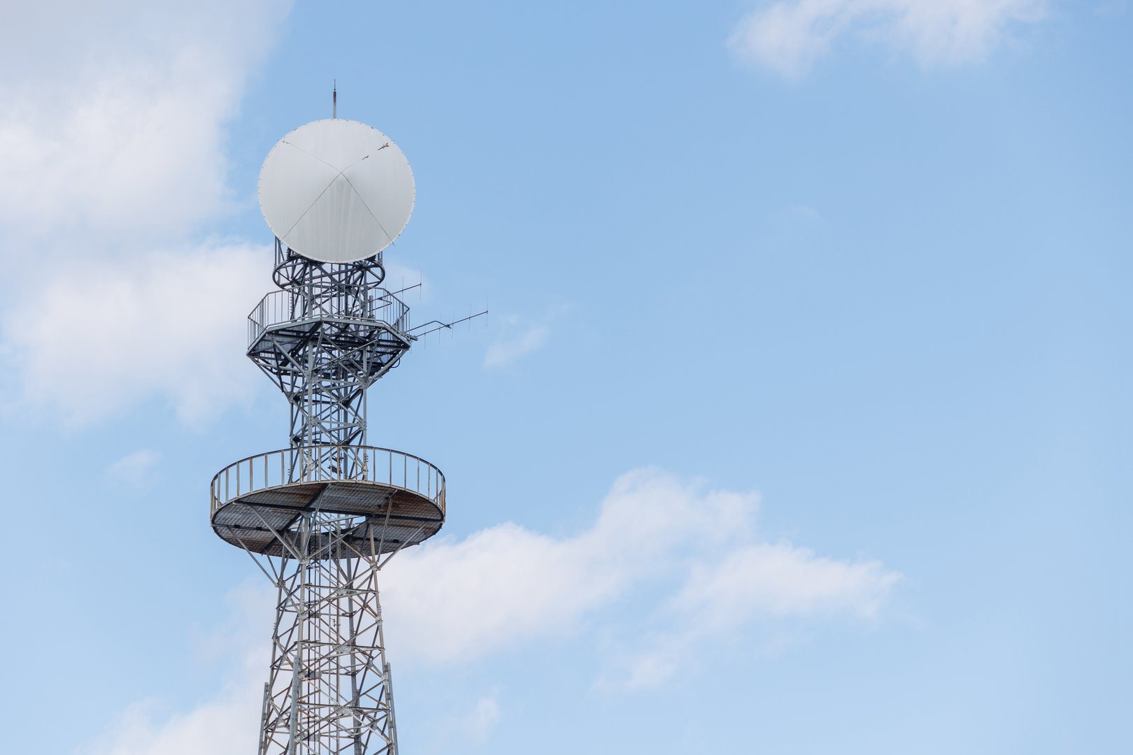 Long range communication tower, Radio Signal Tower, Digital satellite data transmission tower on blue sky with copy space for text.