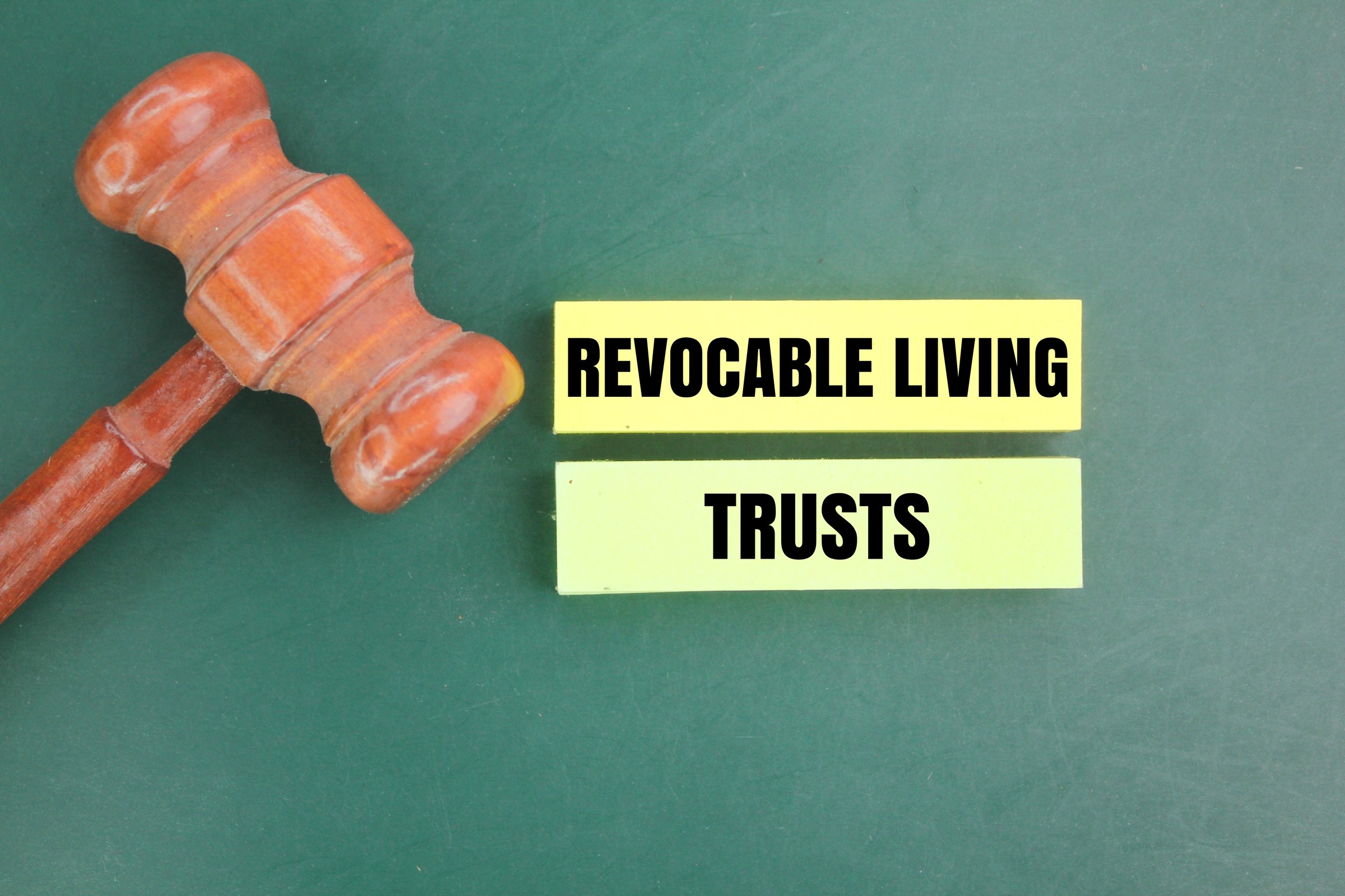 Judge's hammer and colored paper with the words Revocable Living Trusts