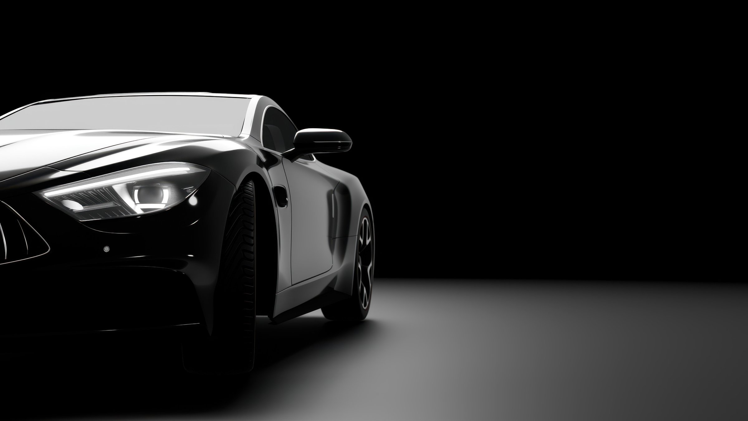 Modern black sports car emerging from the shadows with headlights on, showcasing power and elegance