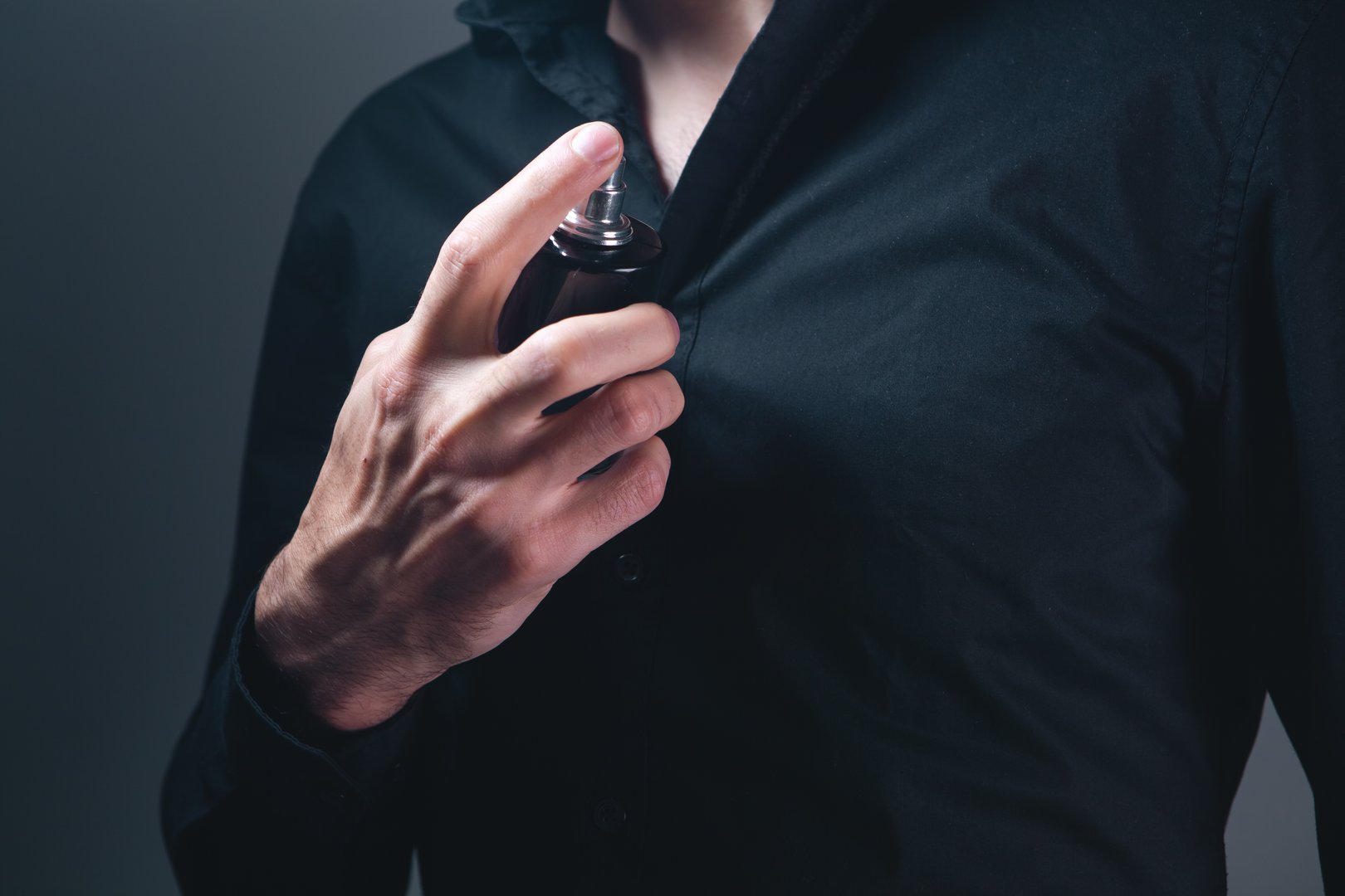 hand with bottle of perfume