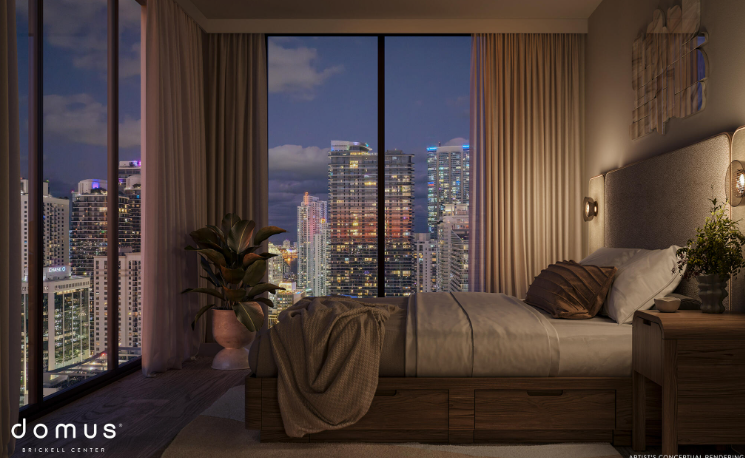 Modern bedroom with a large window view of a cityscape at dusk, featuring tall buildings and soft interior lighting.