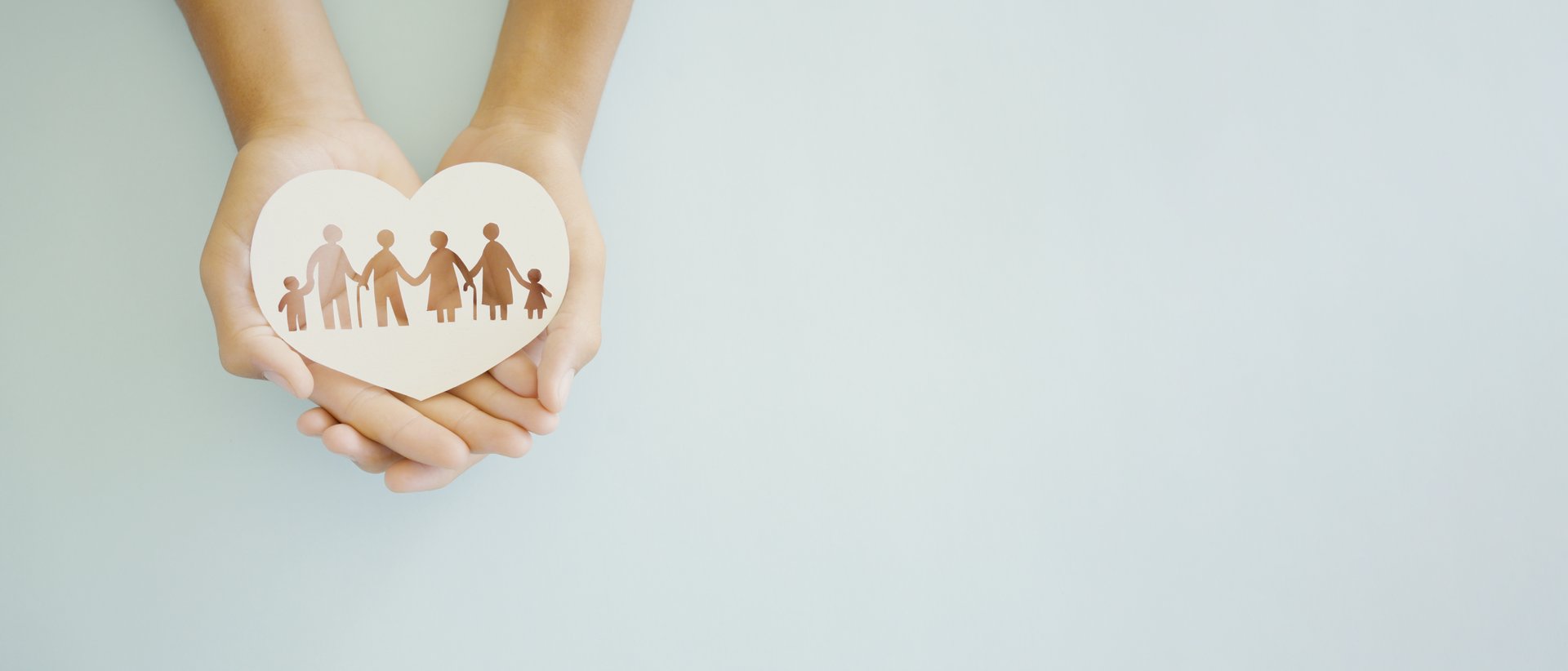 Hands holding multi generation family paper, family wellness, health insurance concept