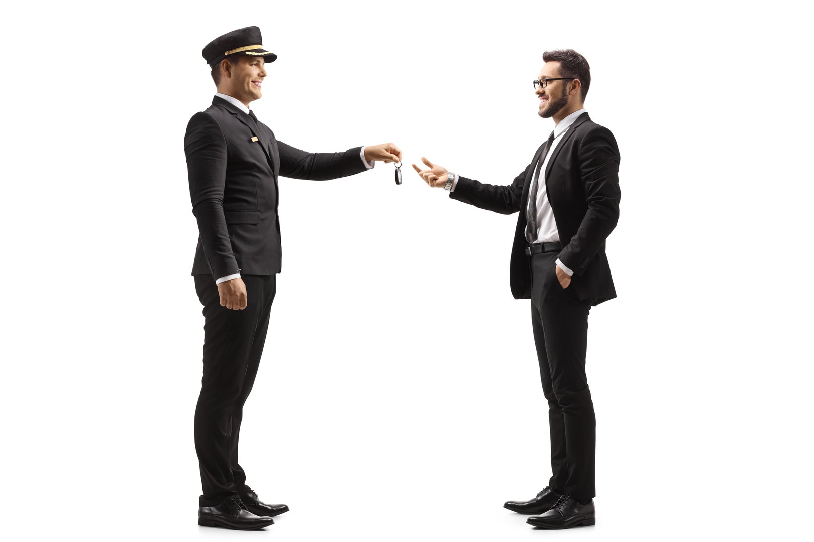 Professional chauffeur eturning car keys to a businessman isolated on white background