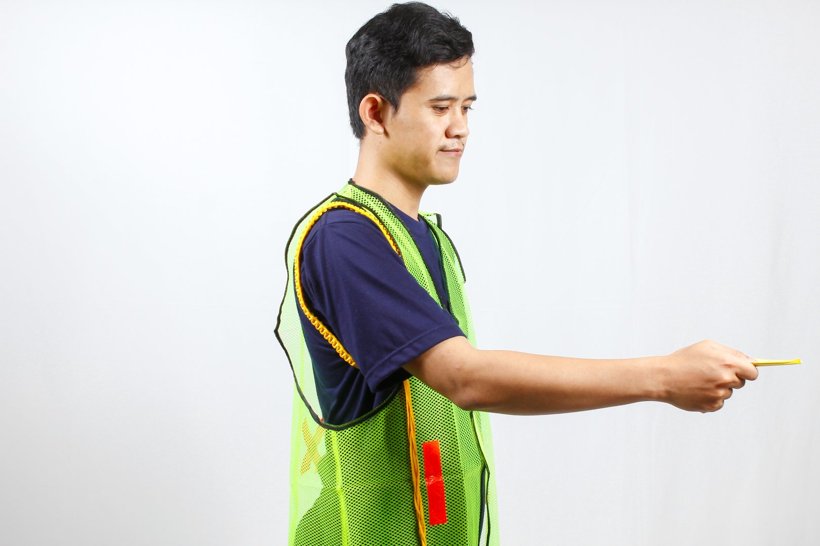 parking attendant wearing green vest giving ticket,isolated on white background
