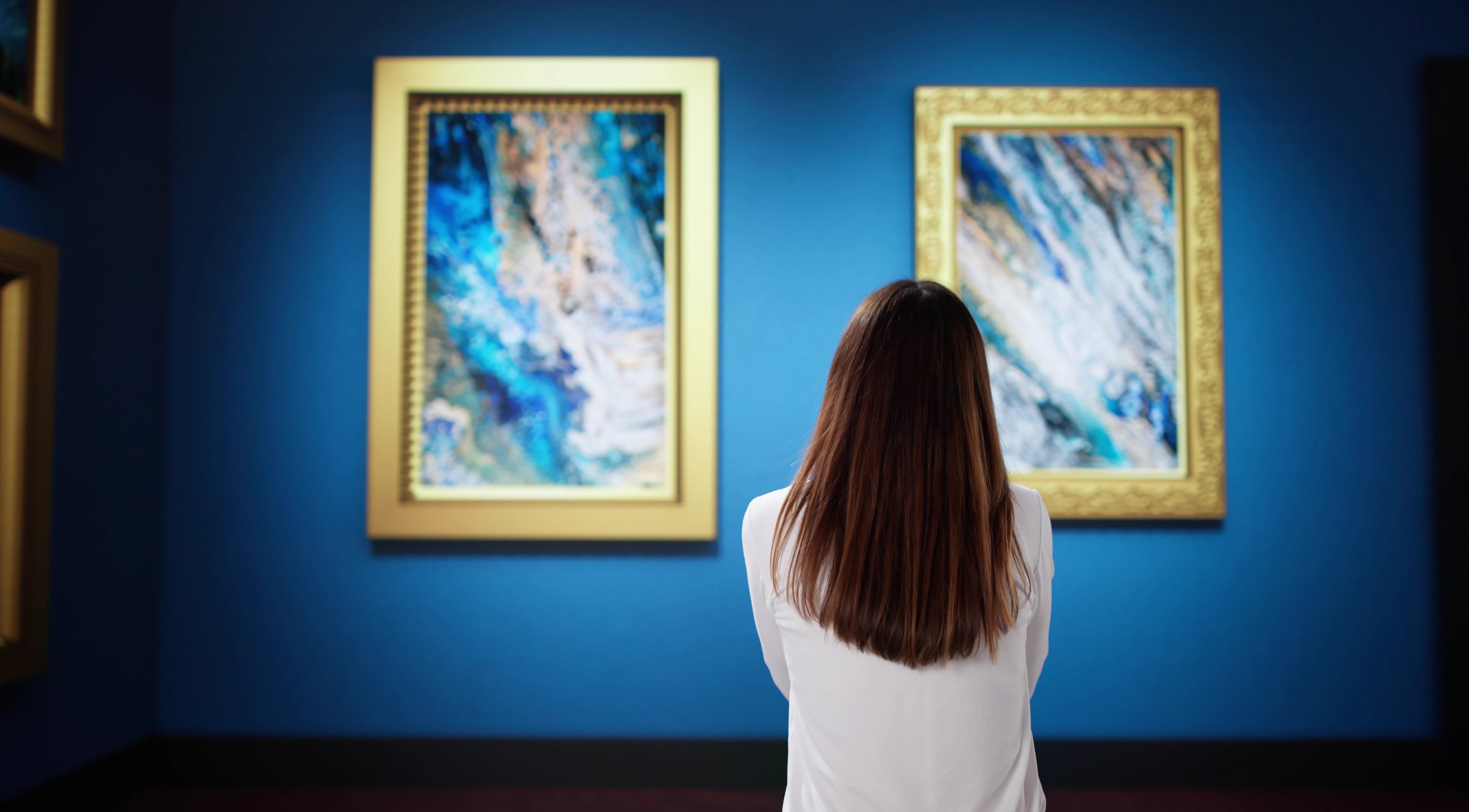 Admiring Unique Artwork at Museum Exhibition Featuring Abstract Paintings and Designs.