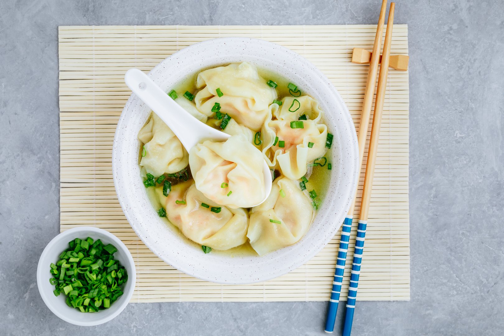 Wonton soup bowl. Shrimp or pork wonton soup with green onion, top view, copy space