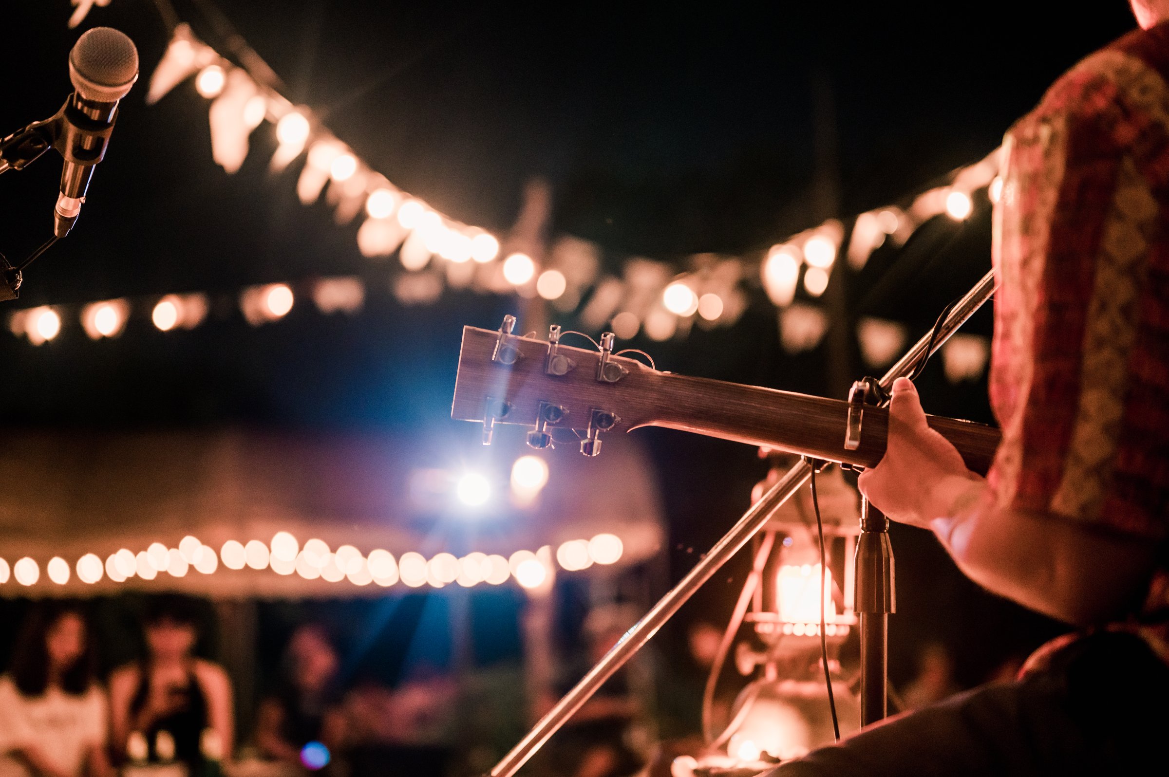 Musicians playing guitar at music festivals, lights,  music, concerts, mini concerts. music festivals