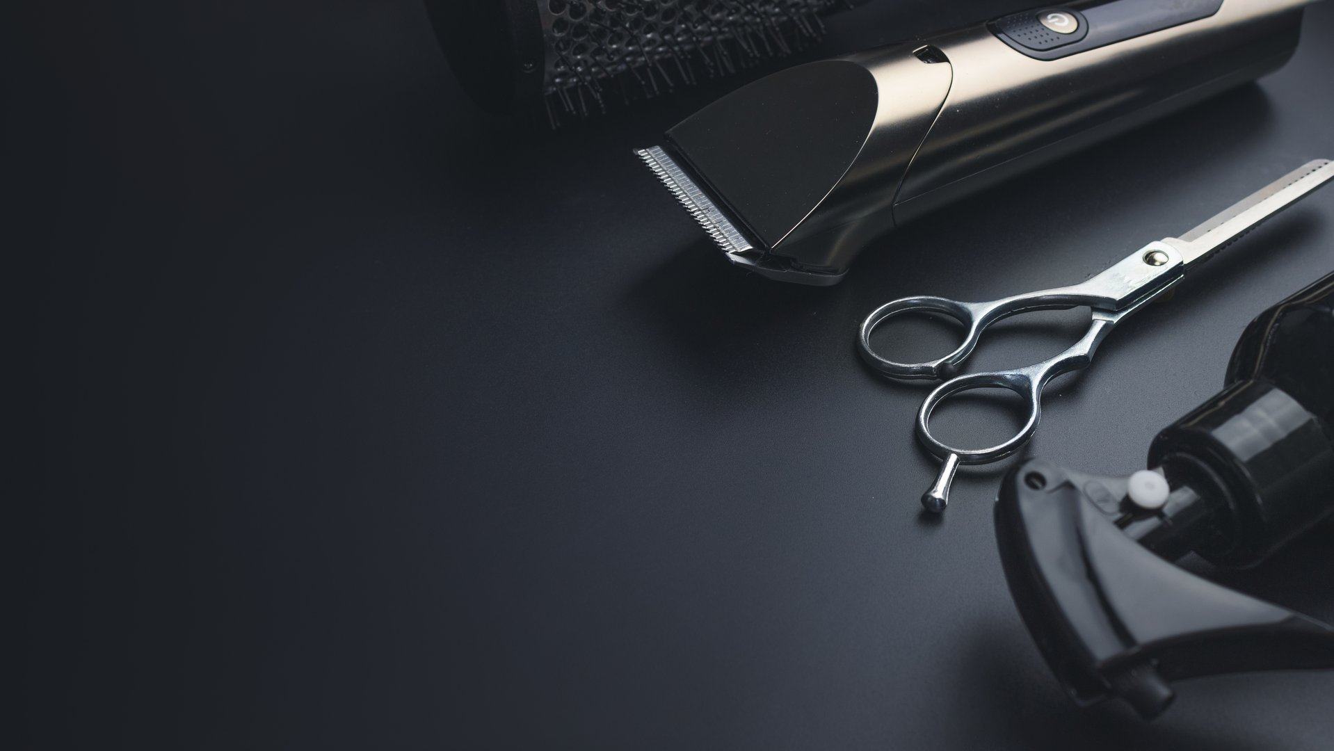 Barbershop concept. Hairdressing tools on dark background top view space for text. Hair extensions, materials and cosmetics, hair care, wig. Hairstyle, haircut in salon