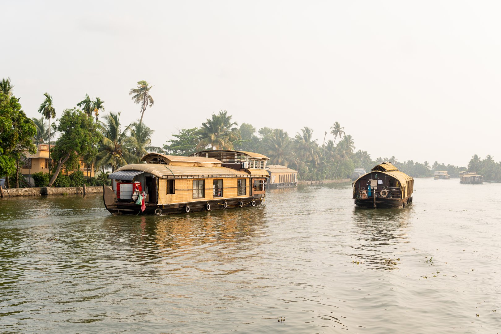 Young attractive girl having a traditional straw houseboat ride on the backwaters of Kerala, India