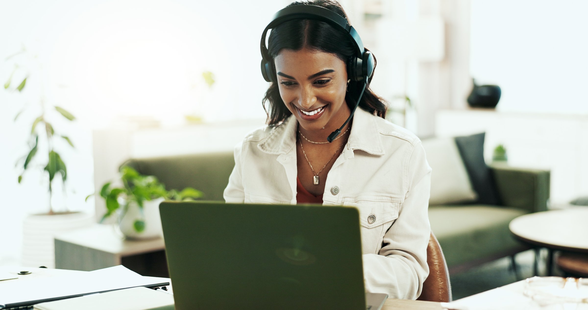 Smile, woman and laptop with headphones in call centre for customer service, telemarketing and sale agent. Happy, advisor and headset for communication, client questions or e commerce advice at house