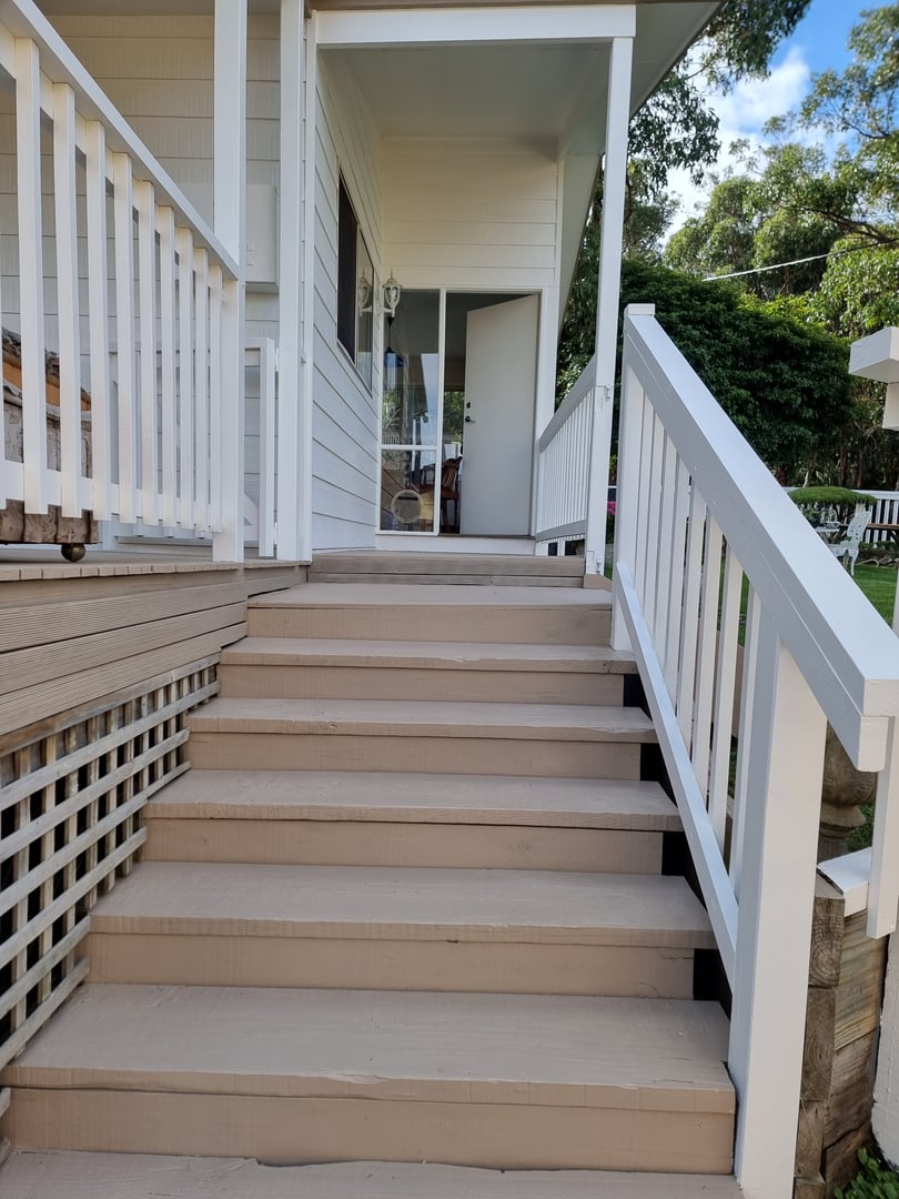 Coastal cottage detail view showing architectural features and paint quality