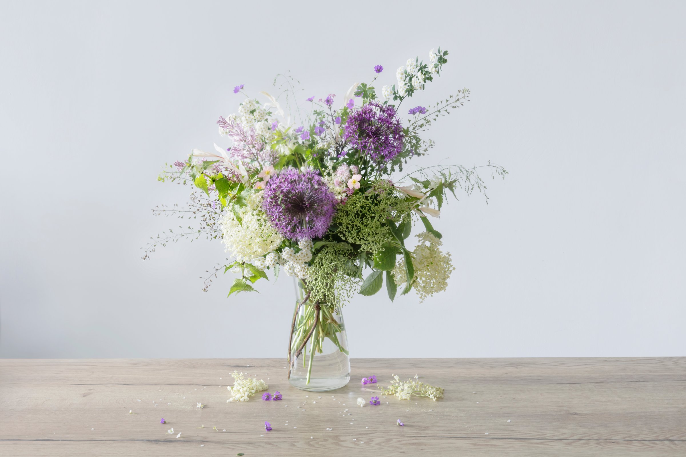 wildflowers in glass vase  on wooden table