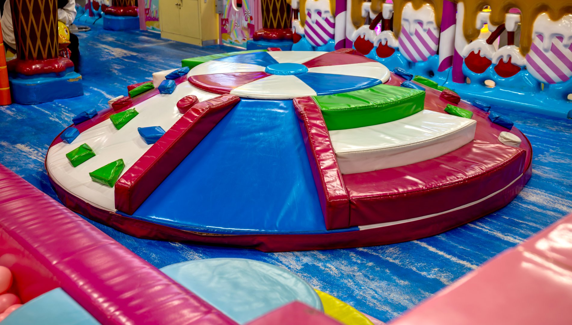 Colorful soft climbing structure in an indoor playground, featuring a round padded design with soft blocks for safe and fun childrens physical activity