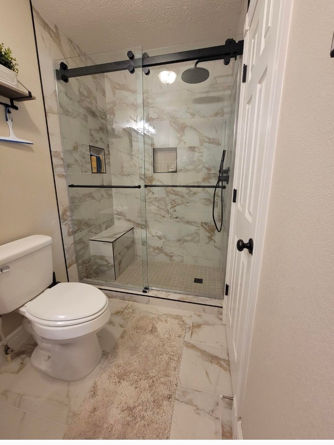 Sliding shower door with matte black hardware