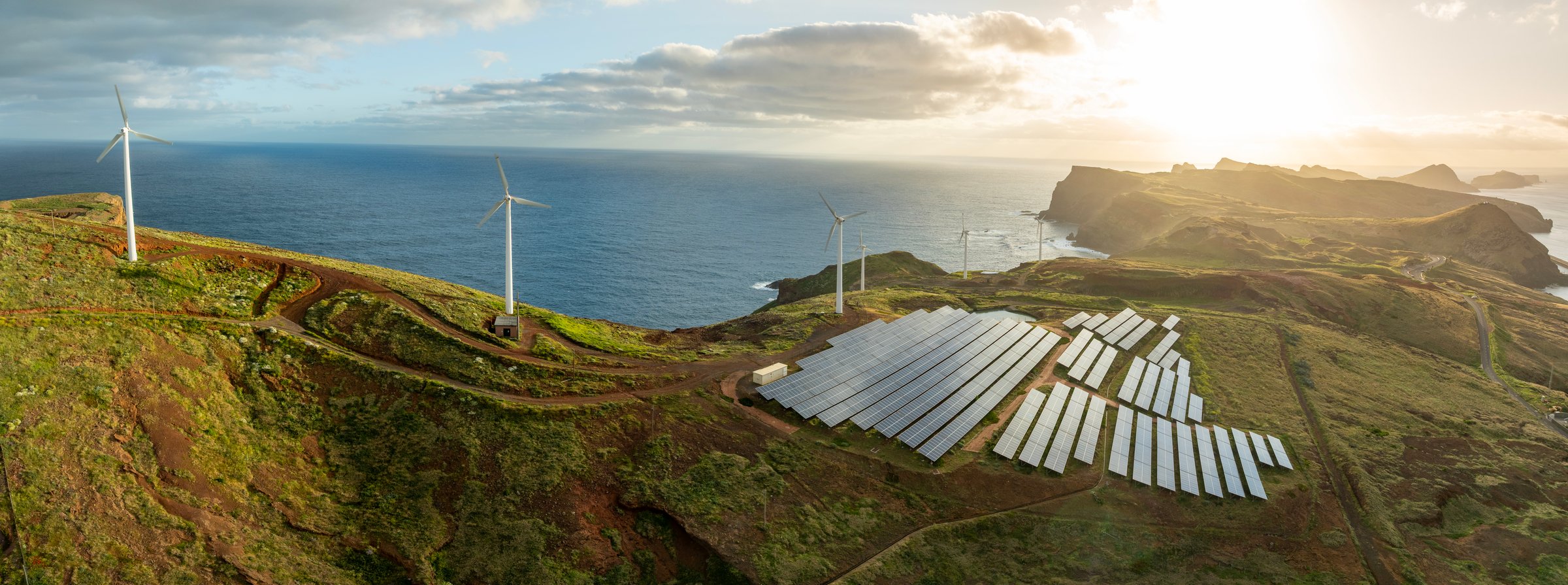 Solar energy panels photovoltaic cell and wind power plants on the seashore landscape for production of renewable green energy