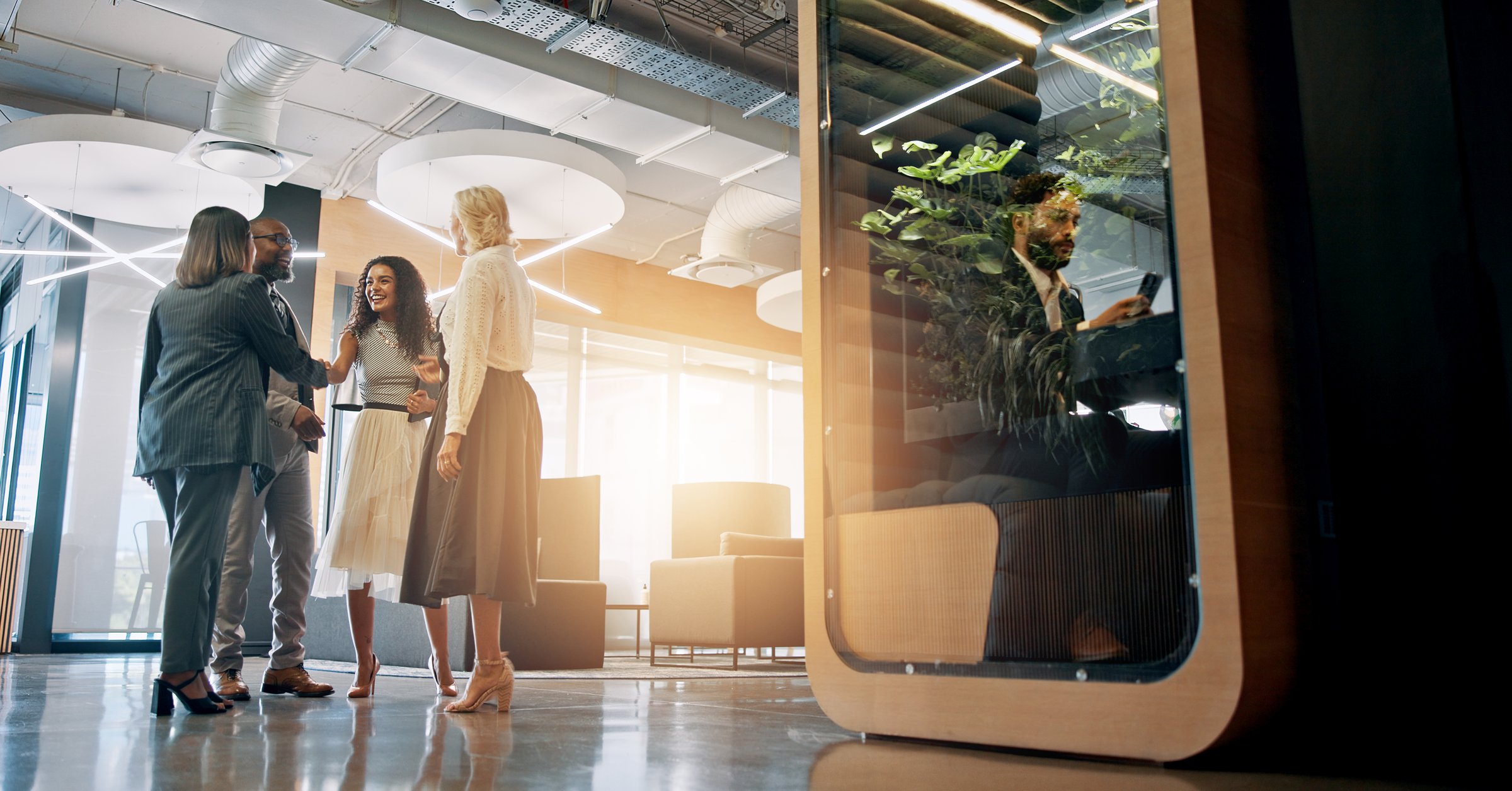 Lobby, corporate and business people with cubicle in office for coworking space for collaboration, teamwork and meeting. Professional, discussion and men and women in workspace pods for productivity