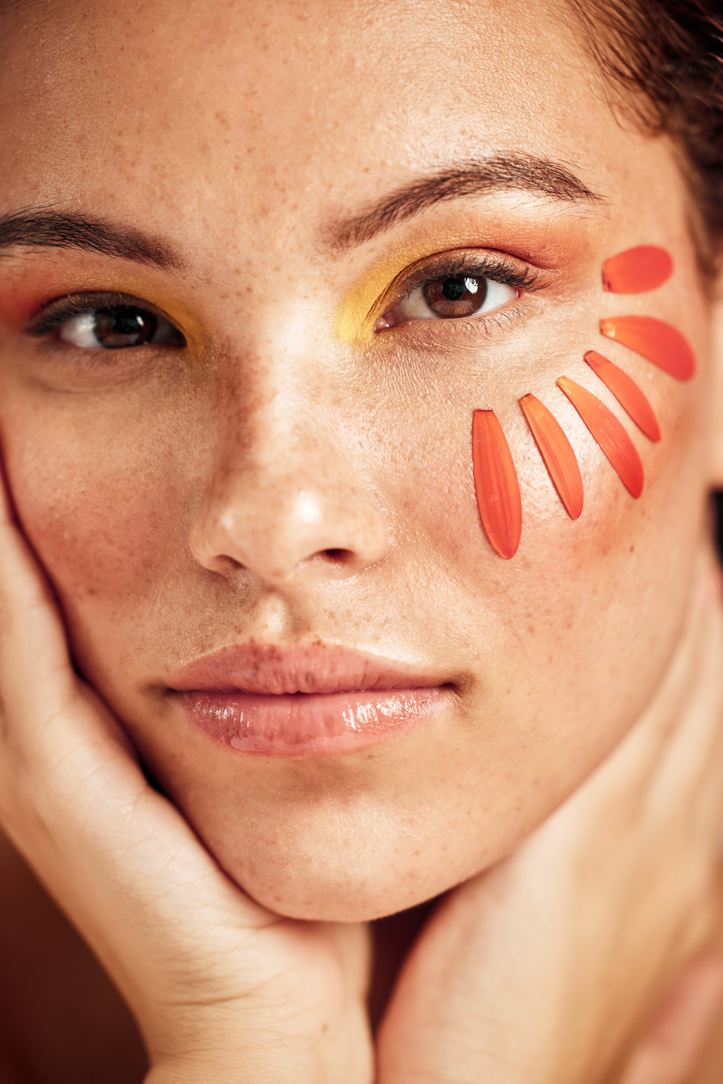 Face makeup, flower petals and woman portrait with creative facial design, floral beauty and color eyeshadow. Luxury skincare, spa salon and model girl with cosmetics isolated on studio background