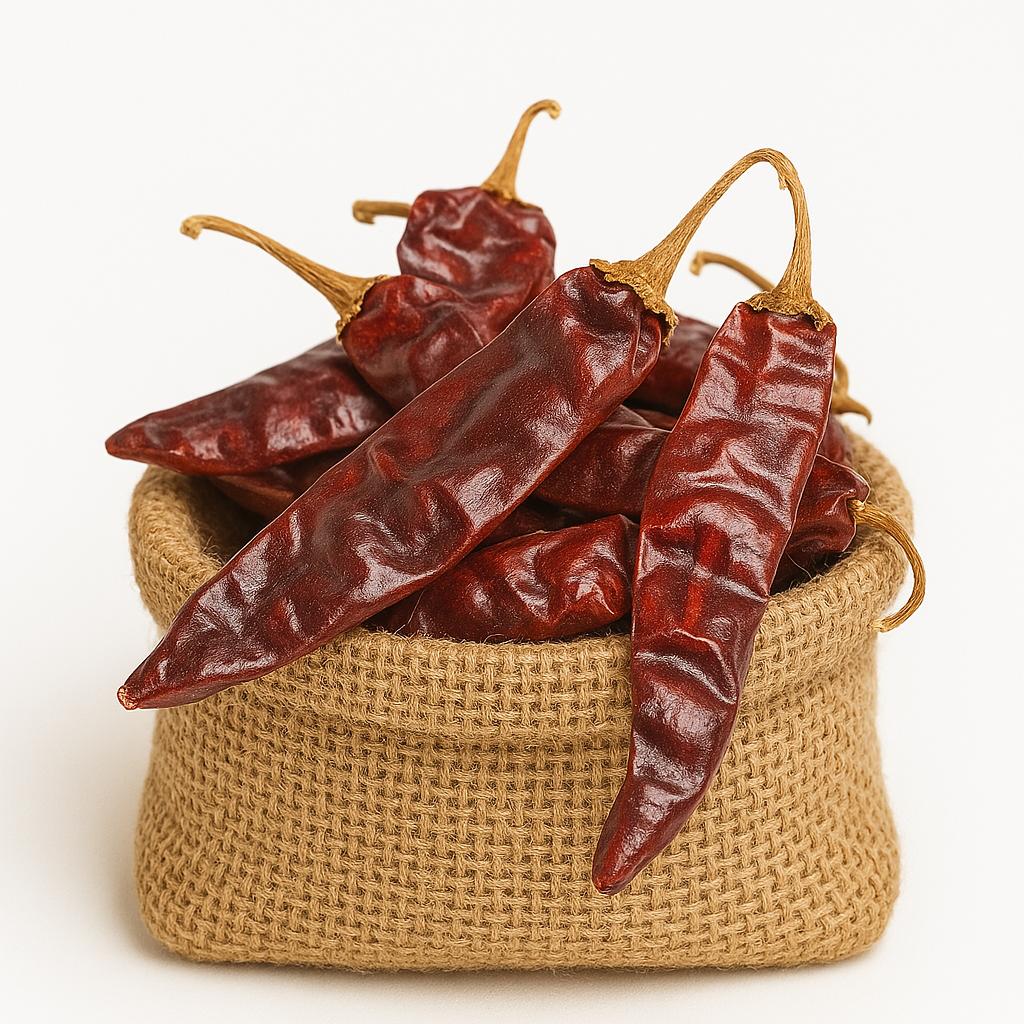 A burlap sack filled with dried red chili peppers, spilling over the edge on a white background.