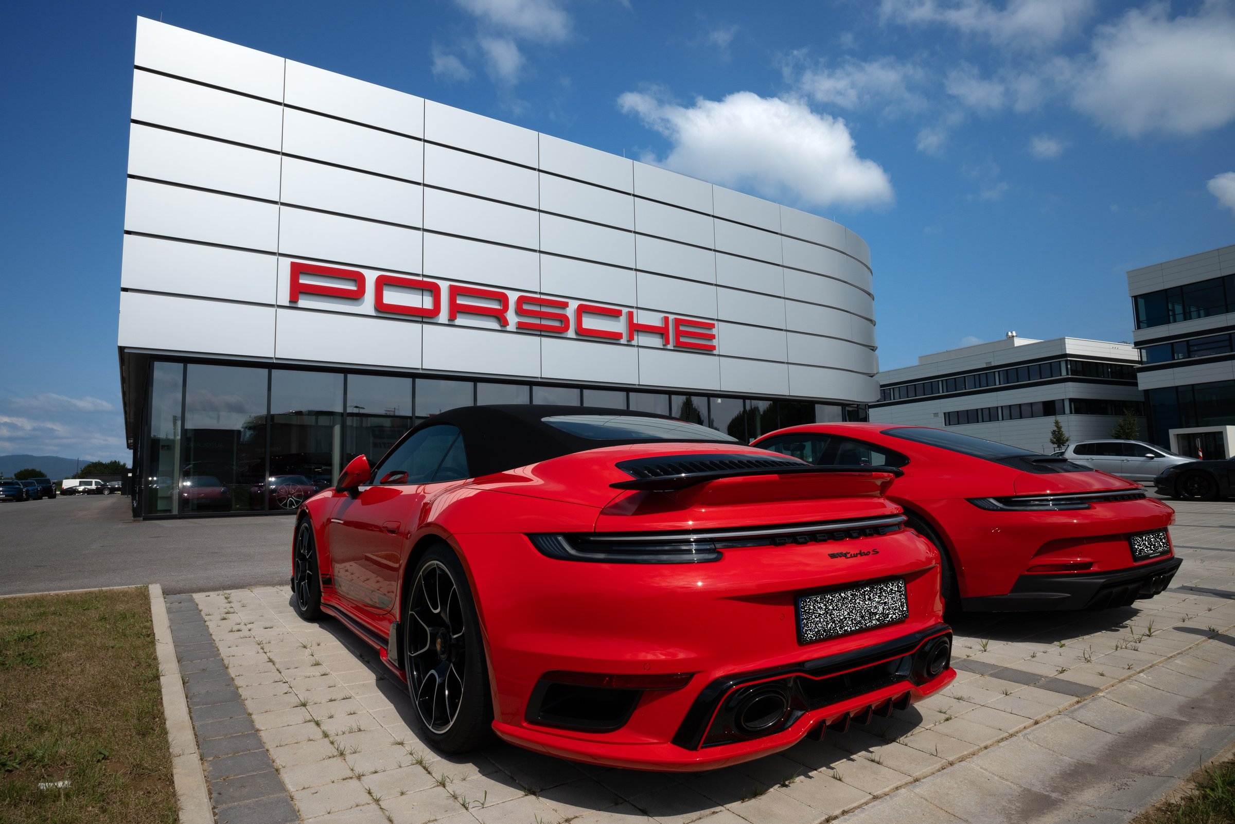 Porsche dealer with two red Porsche cars, one of which is a 911 turbo S, Plattling, Lower Bavaria, Germany