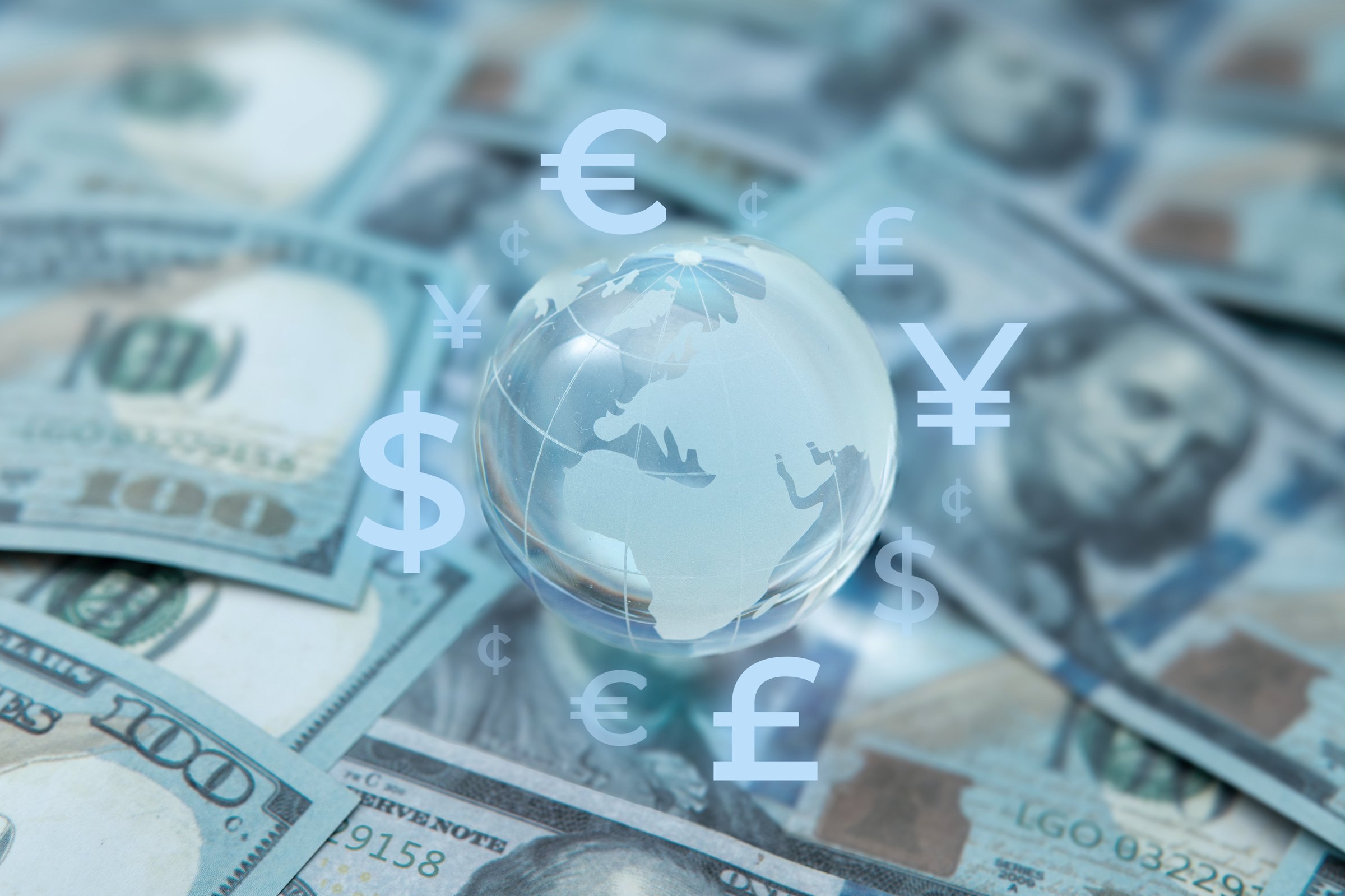 A globe surrounded by various international currency symbols. Global finance, foreign exchange, financial networks and international remittance concept.