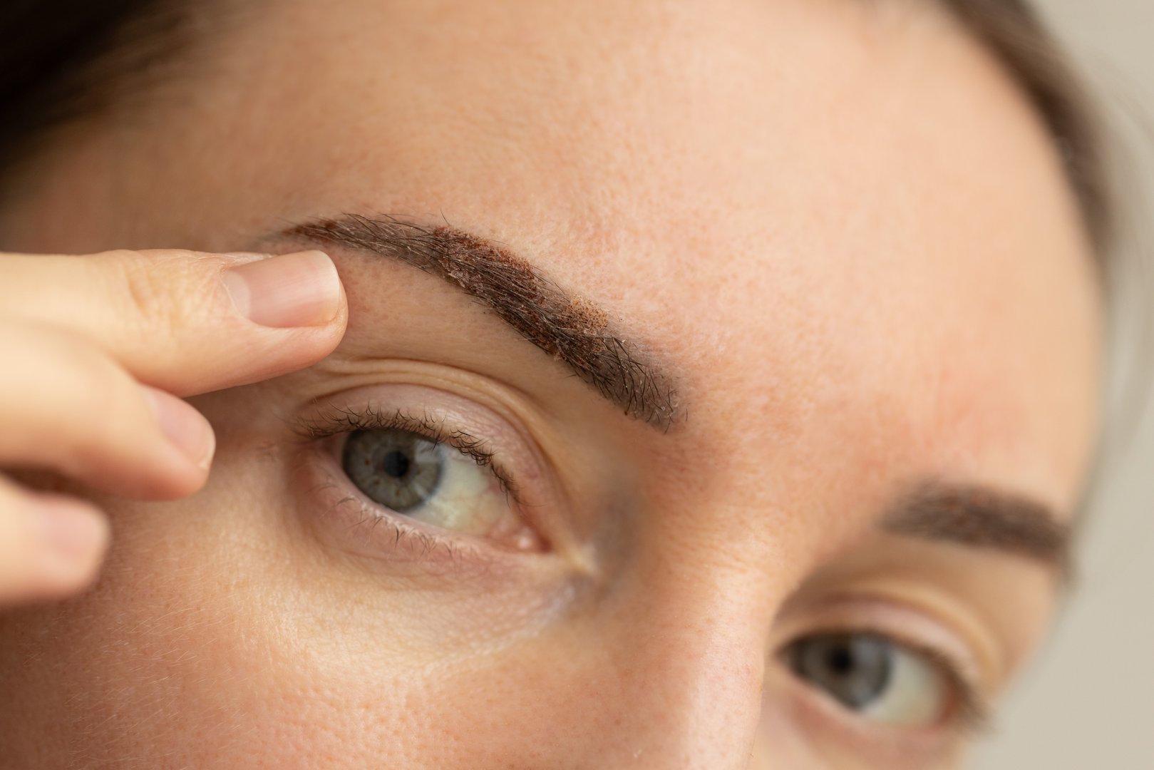 Woman with eyebrows one week after permanent makeup. .