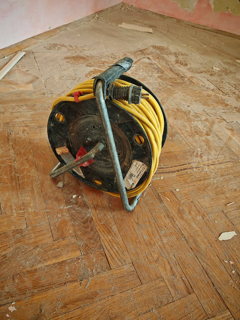 an electrician installing or repairing electric, and pulling cables in a building