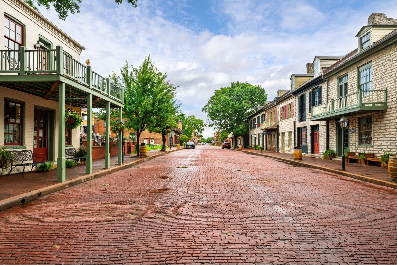 Historic 18th and 19th century buildings along the tree lined and red brick paved Main Street of the charming small town of St. Charles, Missouri. Founded around 1769 by French-Canadian fur trader Louis Blanchette, the city is the oldest on the Missouri River and known for its historic riverfront, annual festivals, and tourist attractions