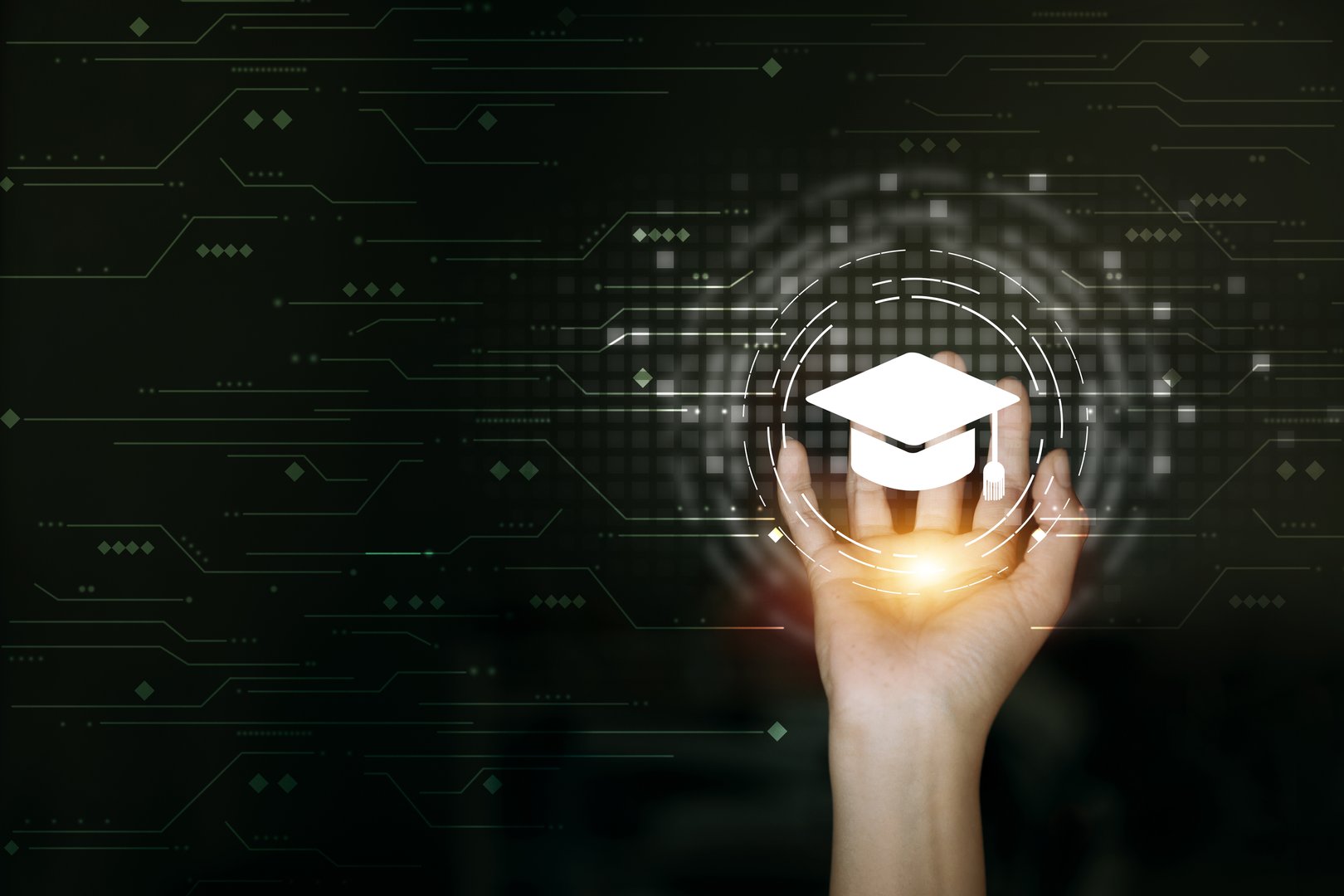 A hand holds a holographic graduation cap, symbolizing digital learning and the future of education.