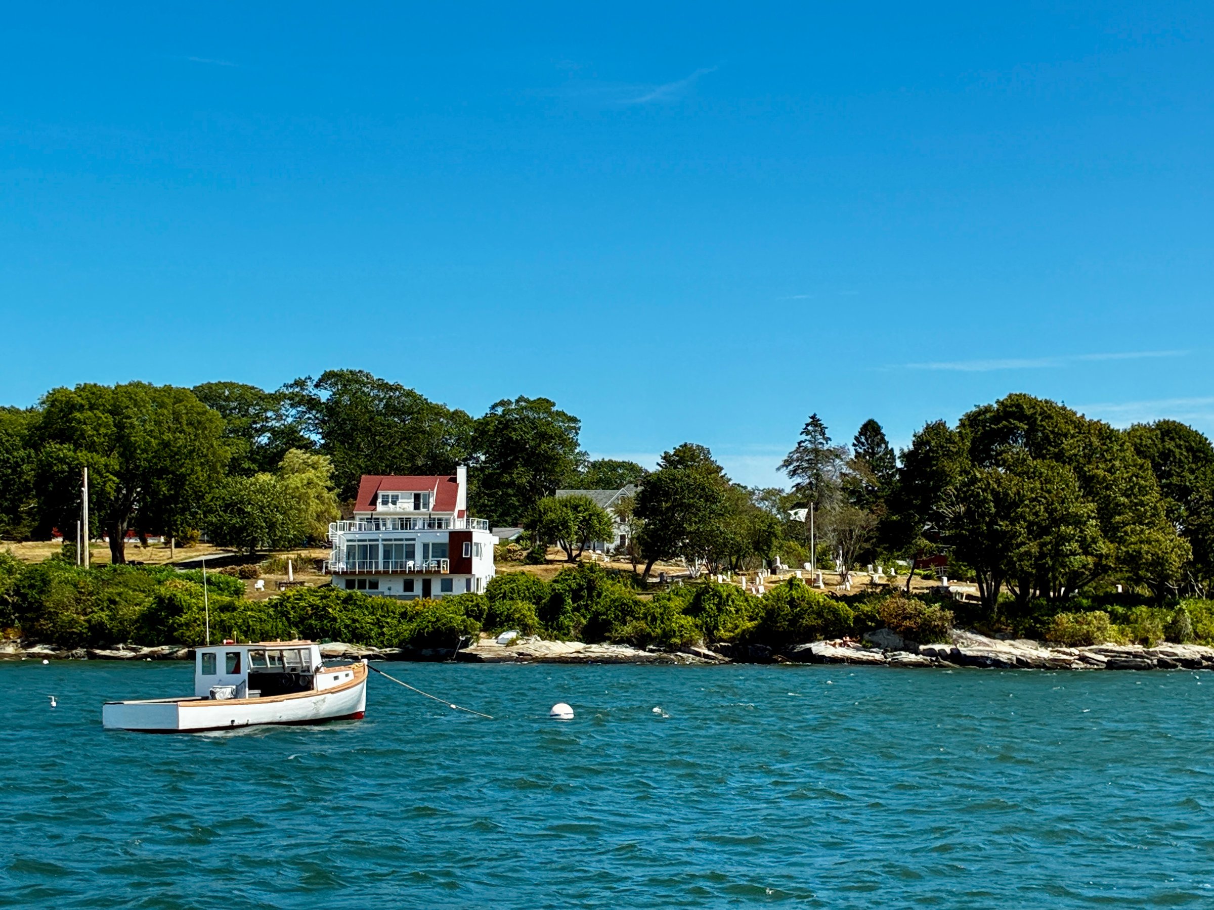 A boat, moored offshore in Maine