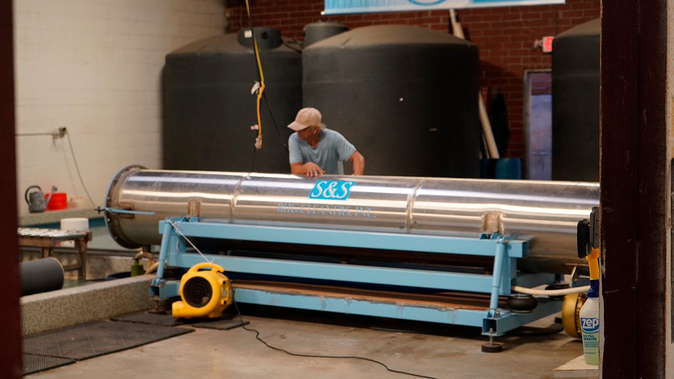 Professional rug cleaning facility with industrial equipment for safe and thorough area rug washing and restoration