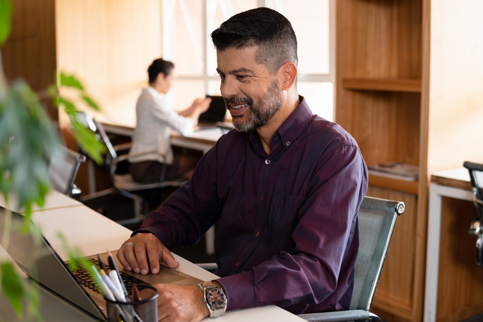 mature business man working and typing in laptop in workstation.