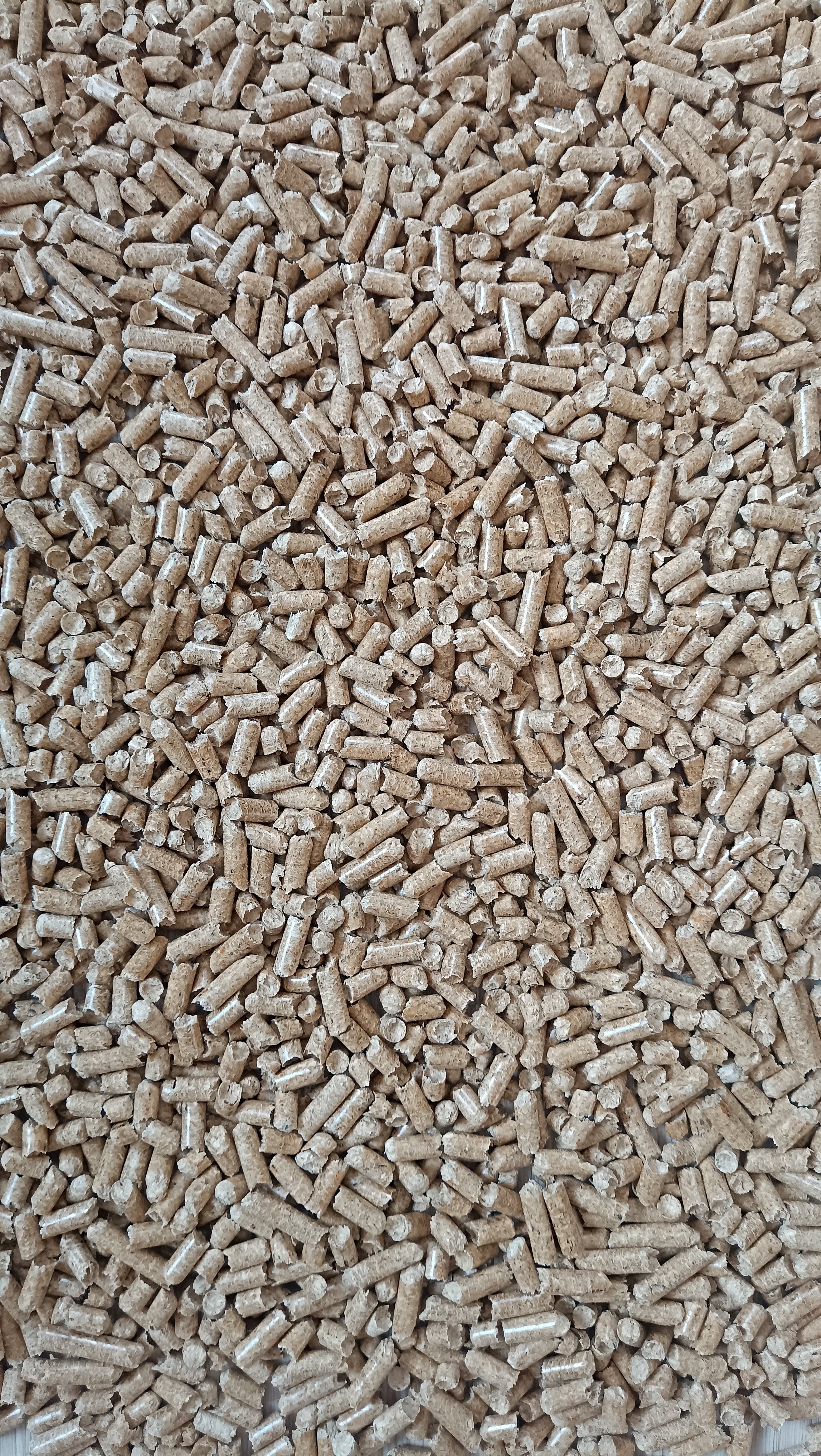 Background with the texture of wooden pellets for heating. Warmth. Heating, environmental protection.