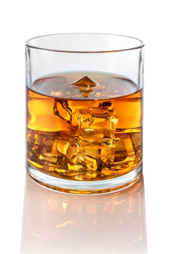 Glass of whiskey or bourbon with ice cubes, Whiskey on the rocks, isolated on white with clipping path included