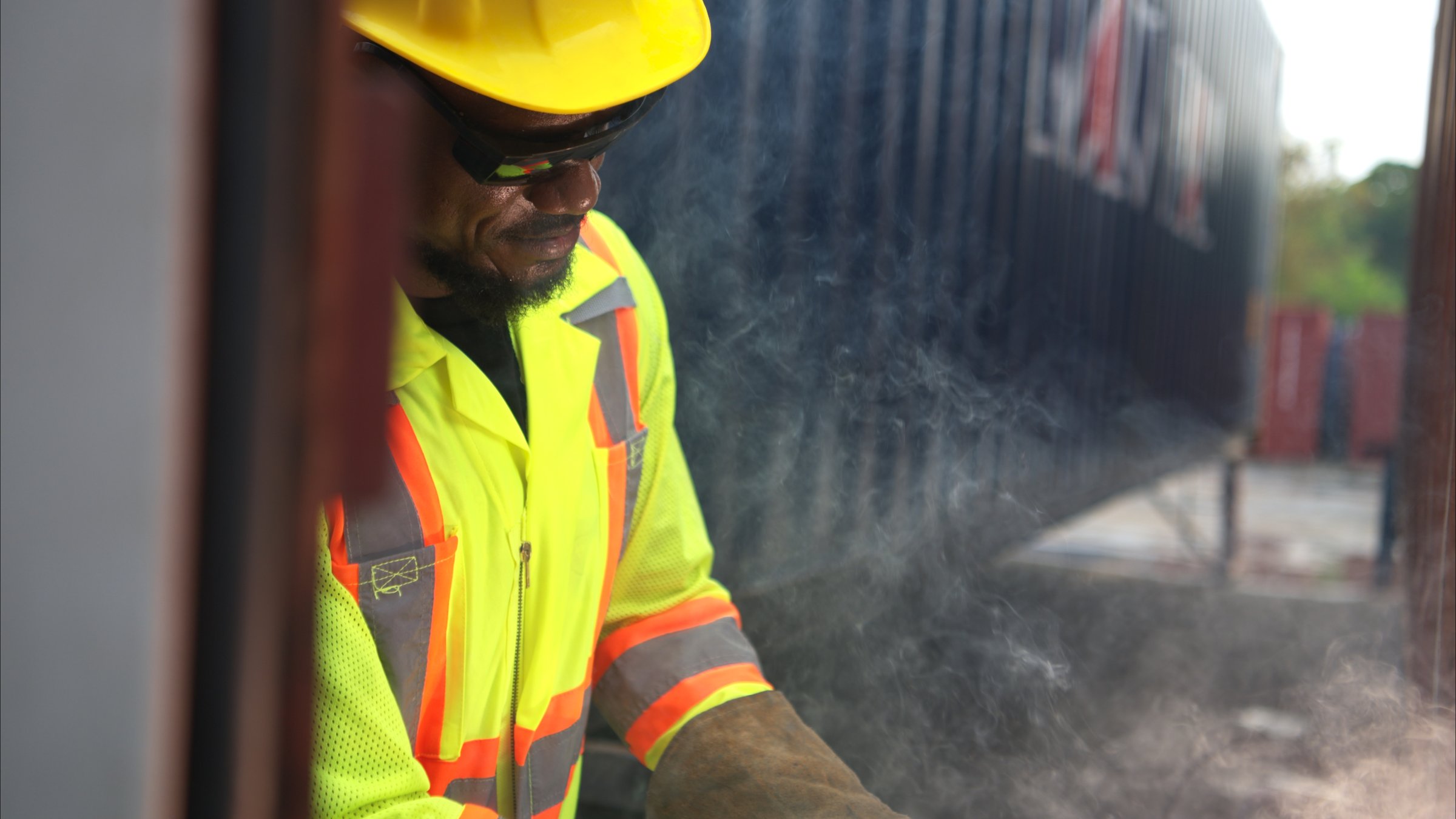 Technicians inspect container repairs by welding at container manufacturing and storage facility