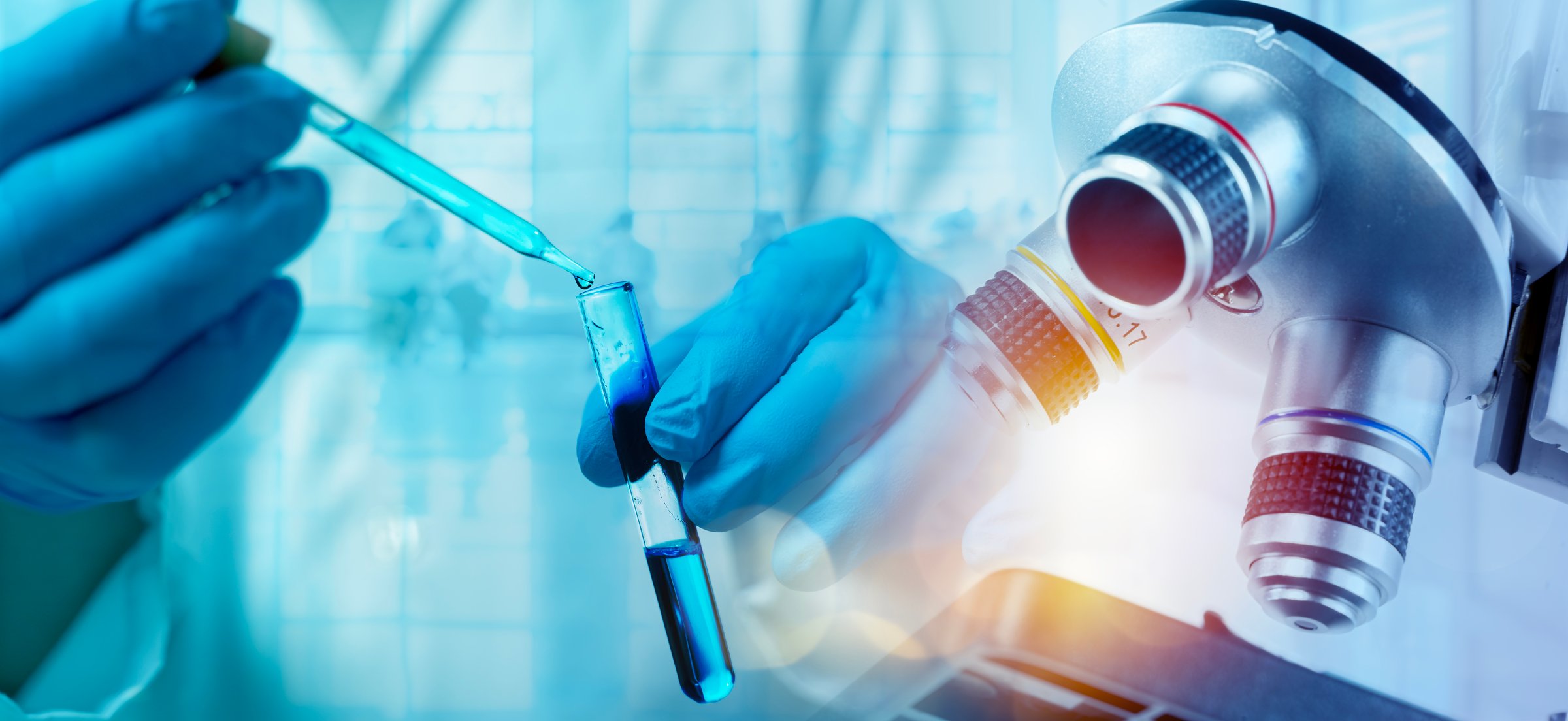 Close up of scientist hand with pipette dropping blue liquid into test tube under microscope in research laboratory, symbolizing biotechnology, medical innovation, chemistry, science and discovery