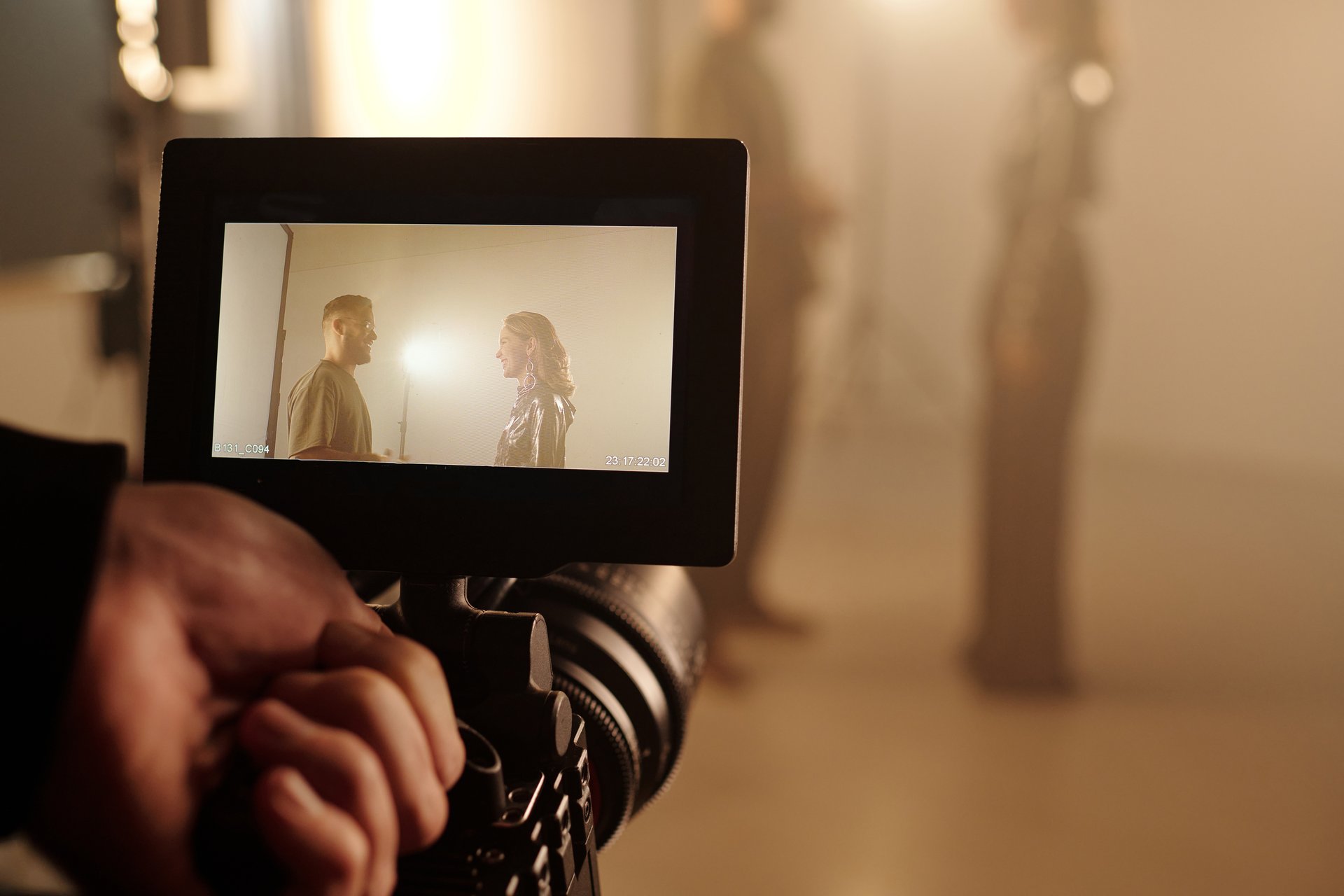 POV shot of cameraman holding camera and filming actors interacting on set, copy space