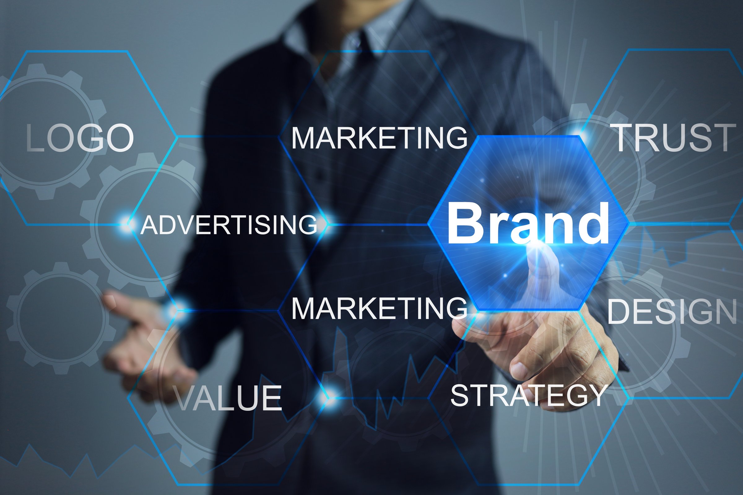 Brand concept, businessman hand reach out to touch on the brand wording to activate the activity of branding key structure