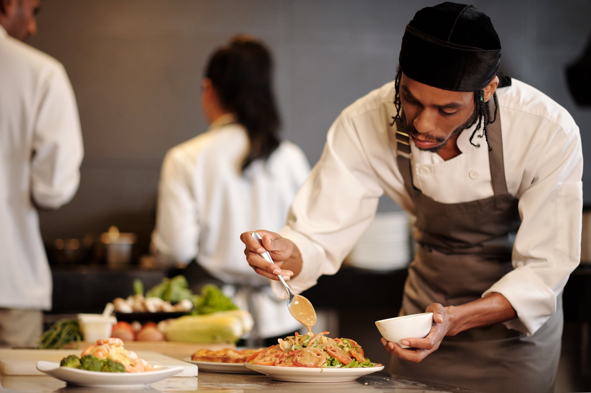 Serious cook pouring thousand island dressing over salad