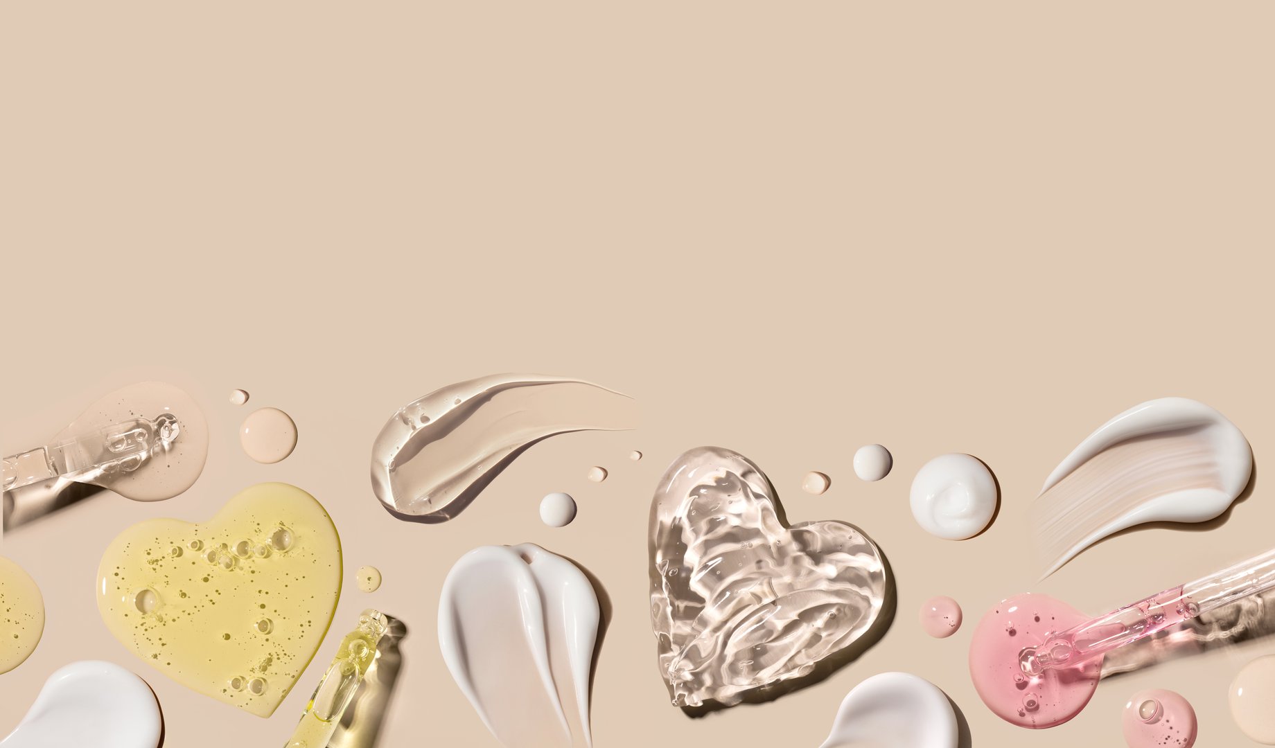 samples of cosmetic care products smear of cream gel texture on a beige background