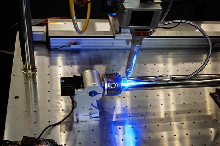 Automated Welding System Demonstrating the Joining of Metal Parts with Precision and Efficiency on a Steel Table.