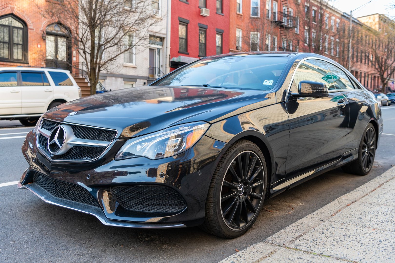 New York City, USA - March 15, 2024: 2014 Mercedes Benz E550 luxury car parked outside, corner view.