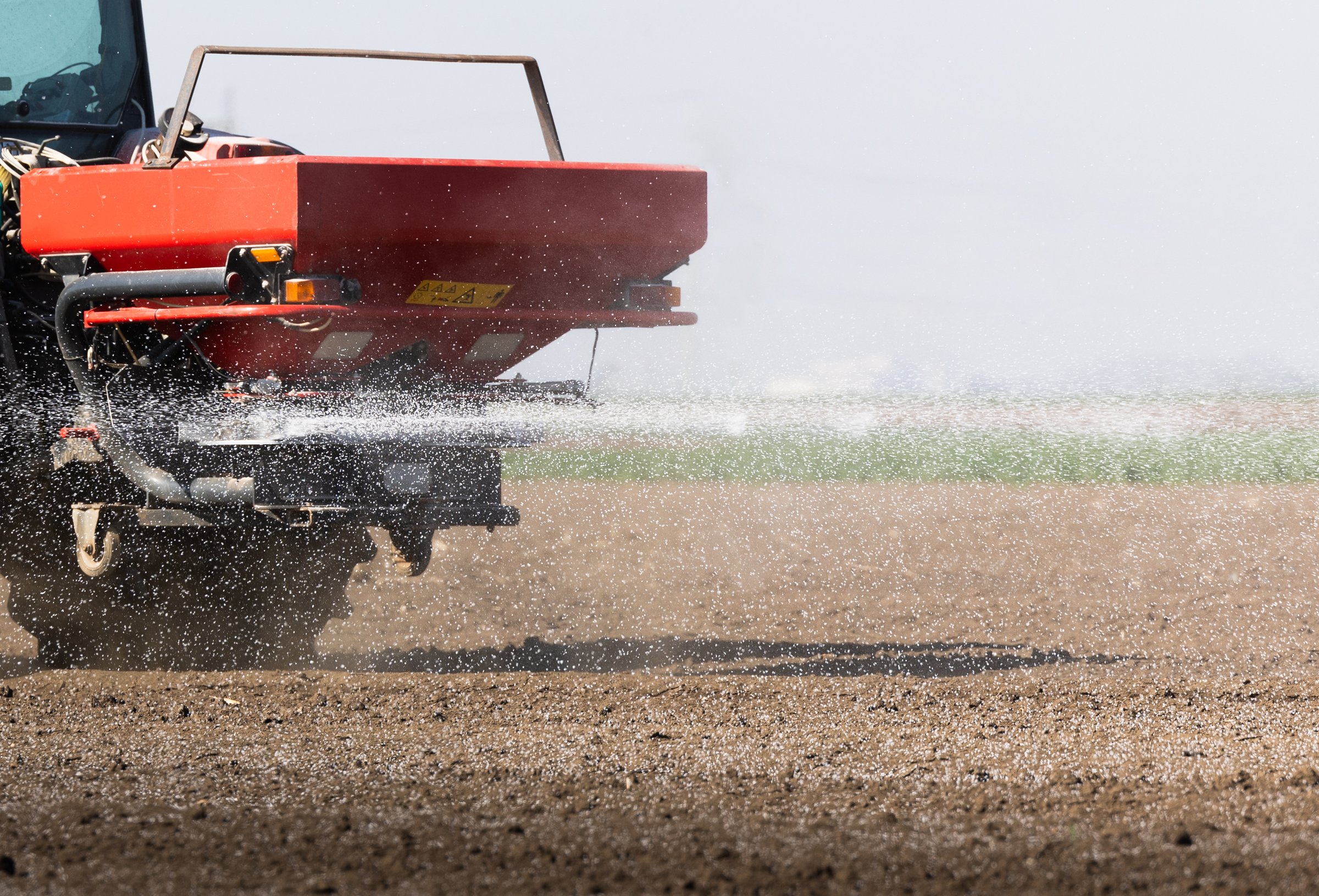 Tractor spreading artificial fertilizers. Transport, agricultural.