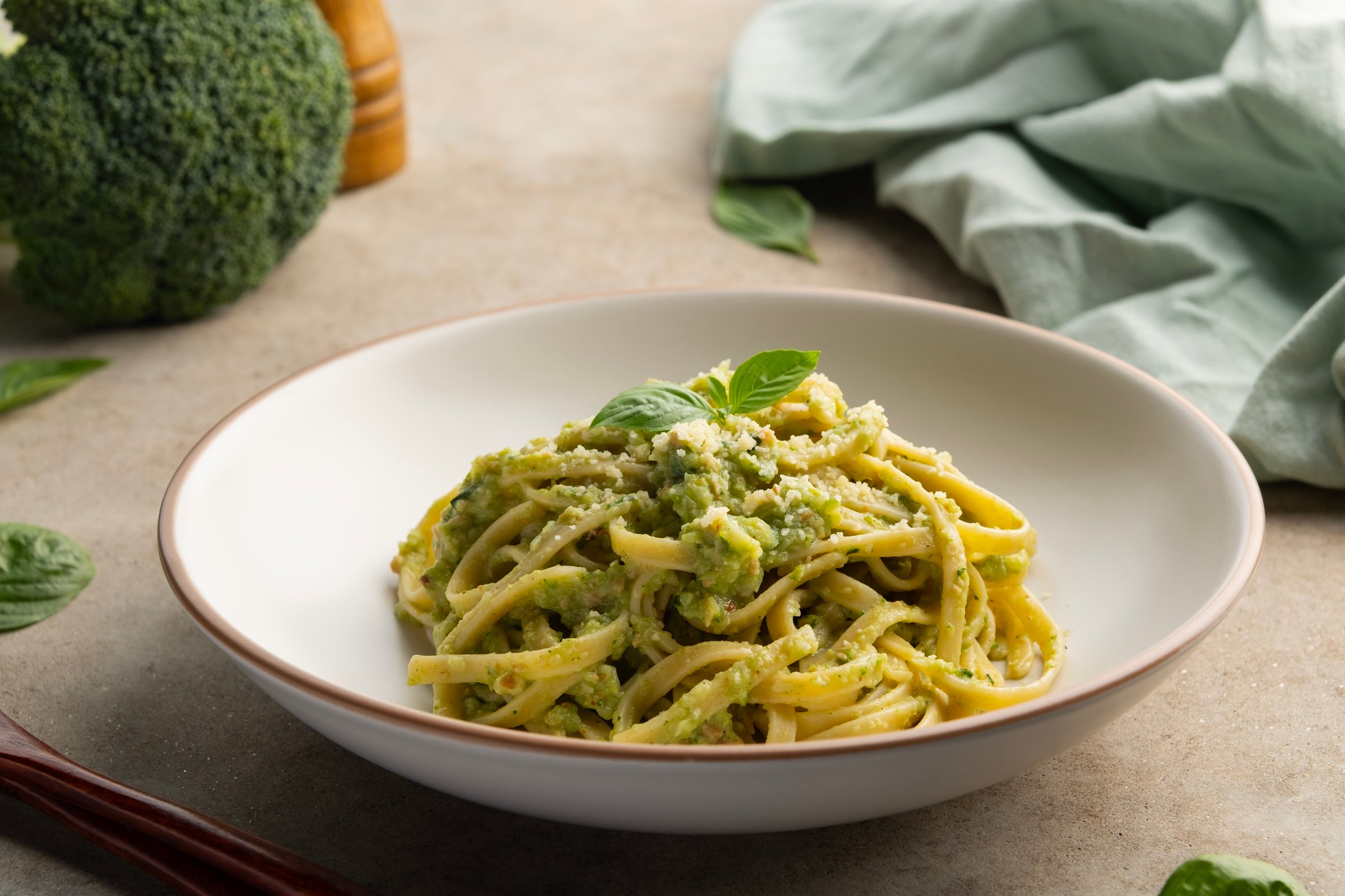 Vegetarian vegan green pasta, Fettuccine pasta with broccoli pesto sauce and cheese in white plate.Healthy food.
