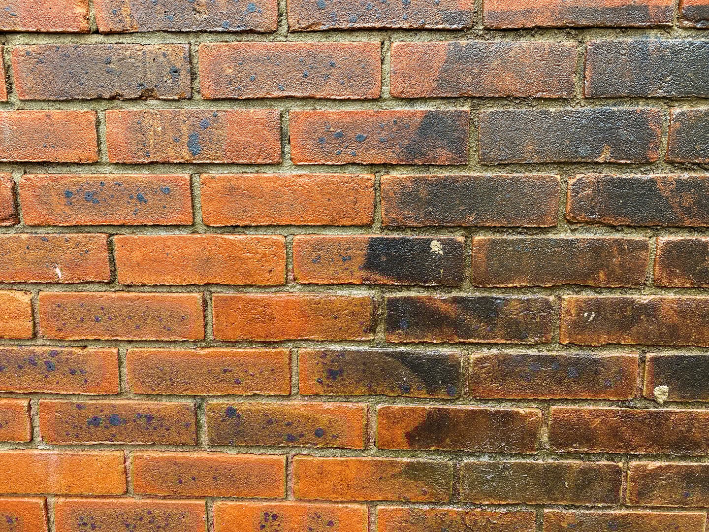 Brick wall before and after pressure washing to clean off the dirt and grime. No people. Copy space.