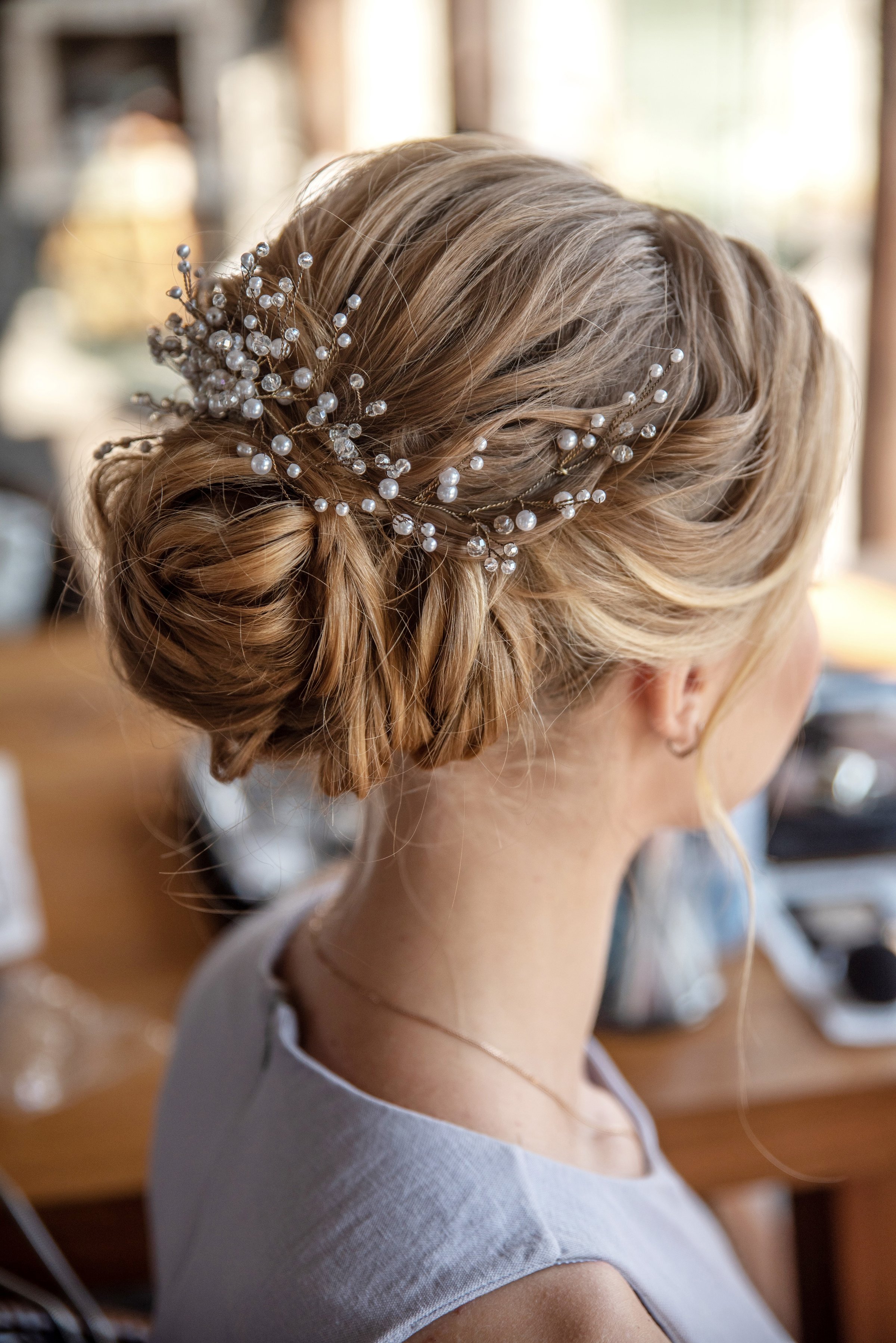 Luxurious wedding pearl hairpin on a bright head