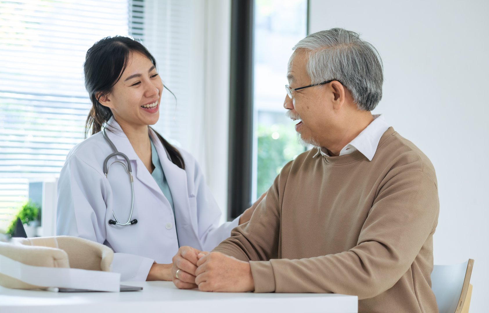 Doctor happily informing senior patient about healthcare options