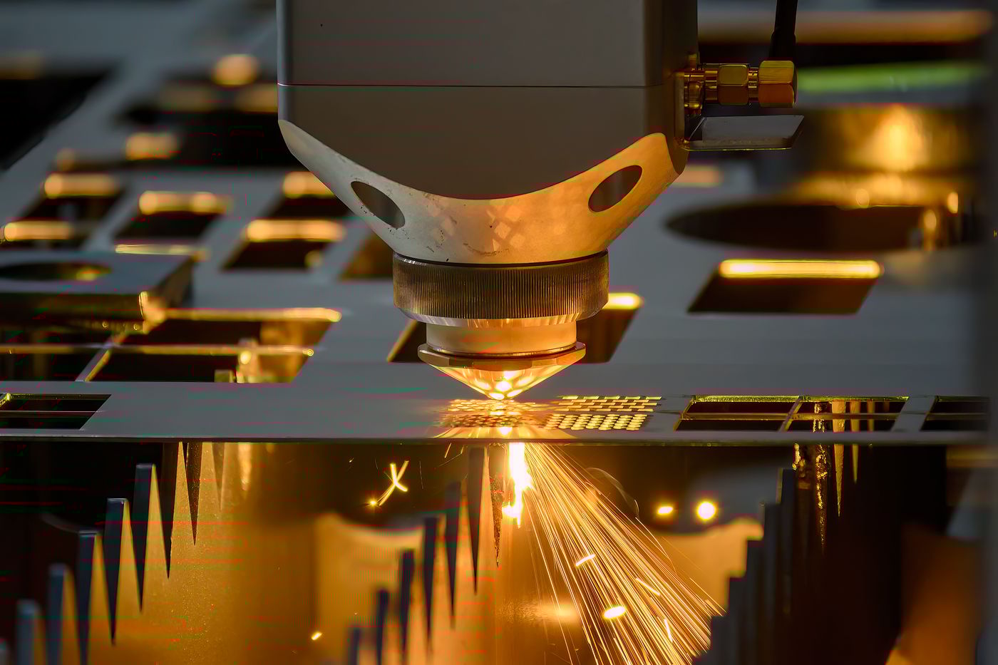 The fiber laser cutting machine  cut the metal plate with the sparkling light. The hi-technology sheet metal manufacturing process by laser cutting machine.