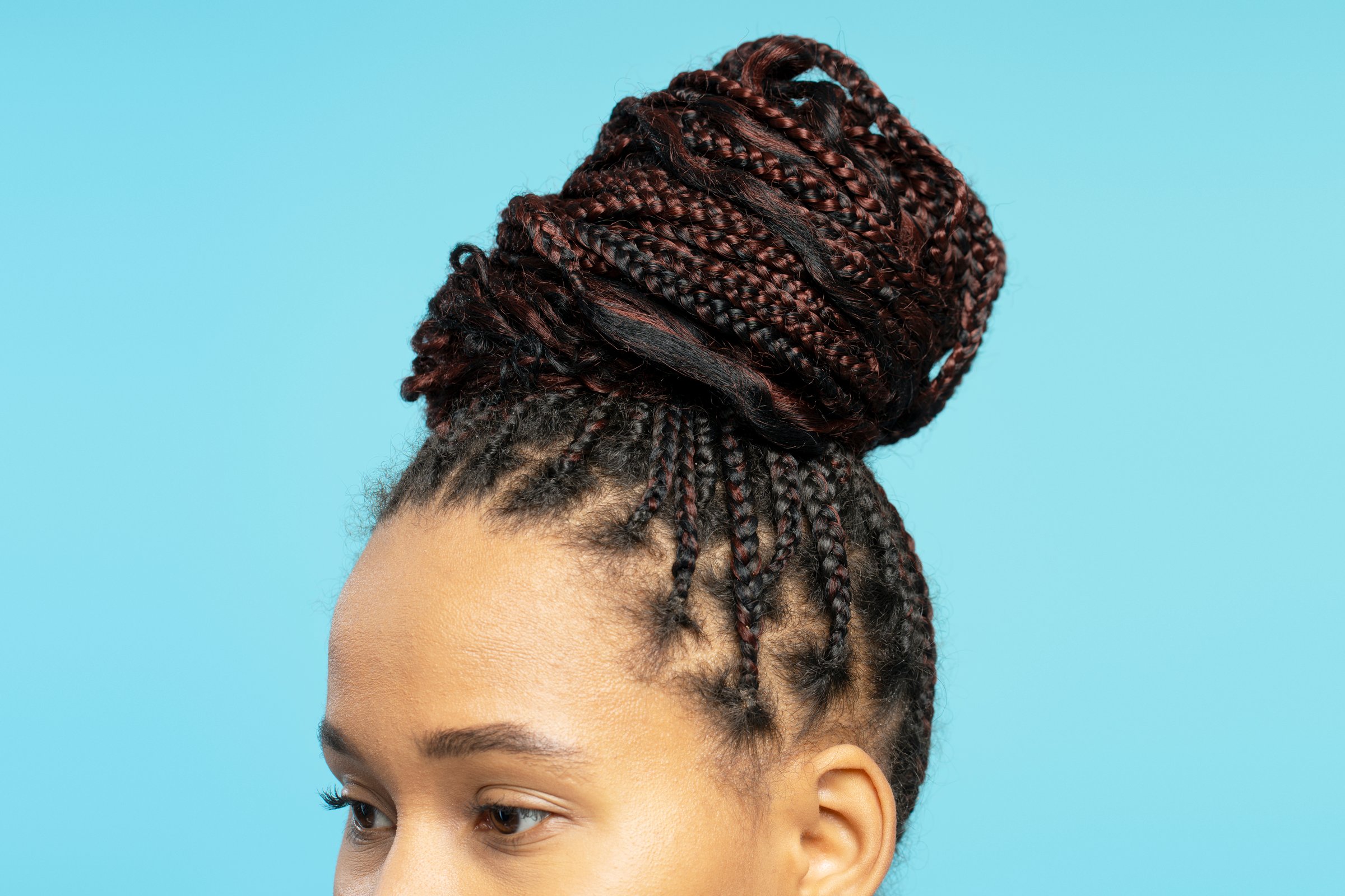 Young woman with braided hair in high bun